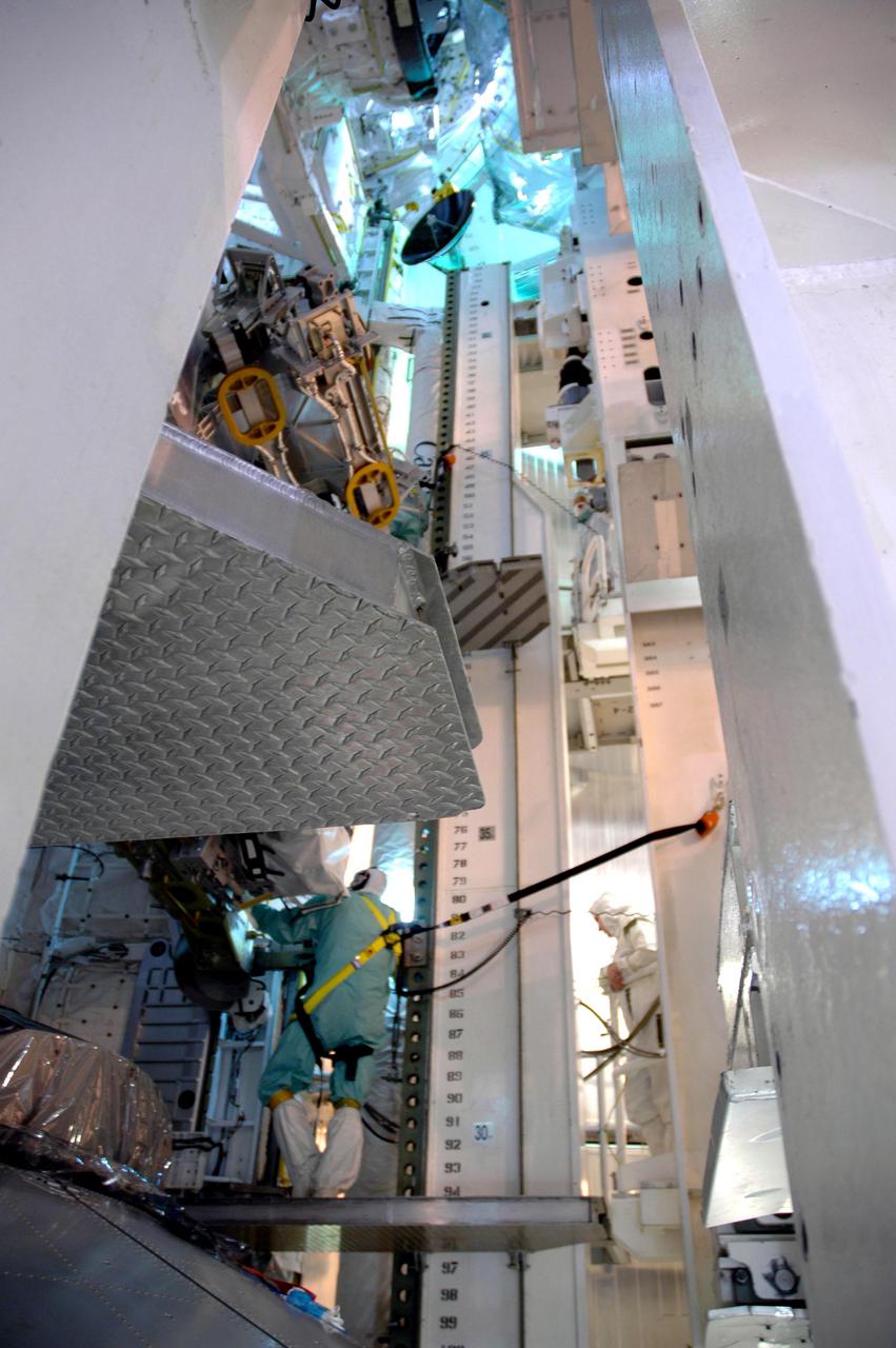 KENNEDY SPACE CENTER, FLA. - In the Payload Changeout Room on Launch Pad 39B, the payloads for Return to Flight mission STS-114 are being transferred to Discovery’s payload bay. Seen here is the Payload Ground Handling Mechanism, which is used for the transfer. Payloads being installed in the bay are a Control Moment Gyro, the Thermal Protection System Detailed Test Objective box, which is placed on the Lightweight Multi-Purpose Experiment Support Structure Carrier, External Stowage Platform 2 and Multi-Purpose Logistics Module Raffaello. Already installed in the payload bay are the airlock, the Canadarm 2, or Shuttle arm, and the Orbiter Boom Sensor System. The launch window for mission STS-114 extends from July 13 to July 31.