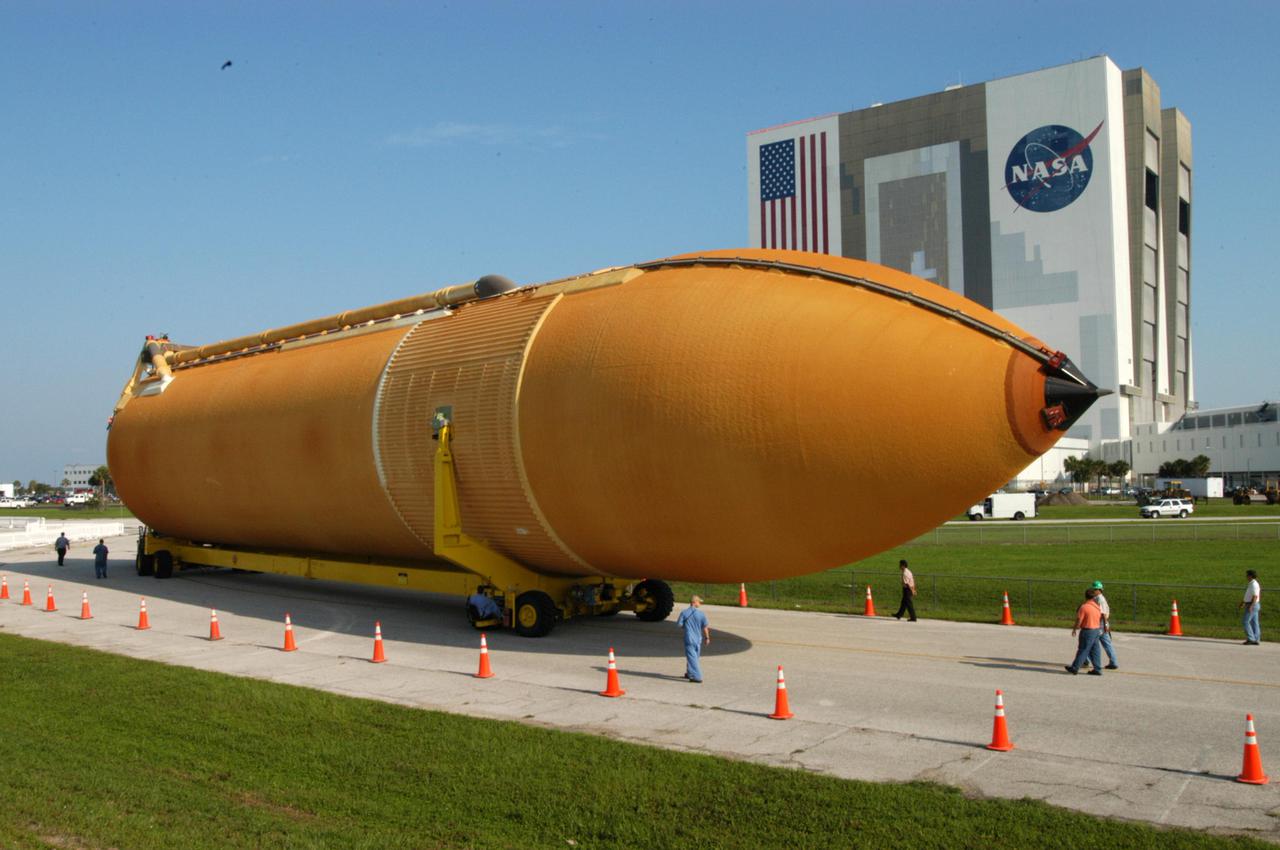 KENNEDY SPACE CENTER, FLA. - A newly redesigned External Tank (ET-119) moves slowly on the road leading from the Turn Basin in Launch Complex 39 Area at Kennedy Space Center, Florida. The tank, which will be used on a future Space Shuttle launch, is being transported to the Vehicle Assembly Building. The barge was towed on a 900-mile journey at sea from the Michoud Assembly Facility in New Orleans by one of NASA’s Solid Rocket Booster Retrieval Ships.