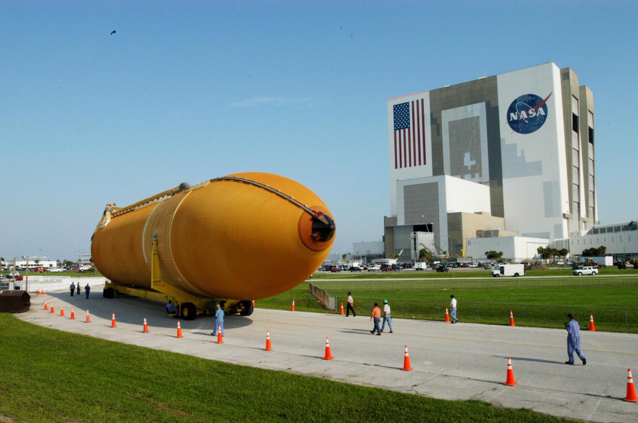 KENNEDY SPACE CENTER, FLA. - A newly redesigned External Tank (ET-119) approaches a turn on the road leading from the Turn Basin in Launch Complex 39 Area at Kennedy Space Center, Florida. The tank, which will be used on a future Space Shuttle launch, is being transported to the Vehicle Assembly Building, seen at right.   The barge was towed on a 900-mile journey at sea from the Michoud Assembly Facility in New Orleans by one of NASA’s Solid Rocket Booster Retrieval Ships.