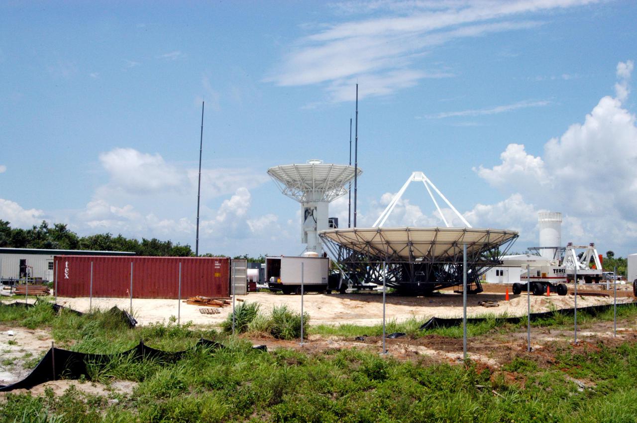 KENNEDY SPACE CENTER, FLA. - On June 8, further progress is made in the erection of a C-band radar antenna at a radar site on North Merritt Island, Fla. The 50-foot C-band radar will be used for long-term Shuttle missions to track the launches and observe possible debris coming from the Shuttle. In the background is an existing 30-foot C-band Pathfinder radar whose use was demonstrated on the Delta Messenger launch. It will be used on the upcoming two Return to Flight missions. The launch window for the first Return to Flight mission, STS-114, is July 13 to July 31.