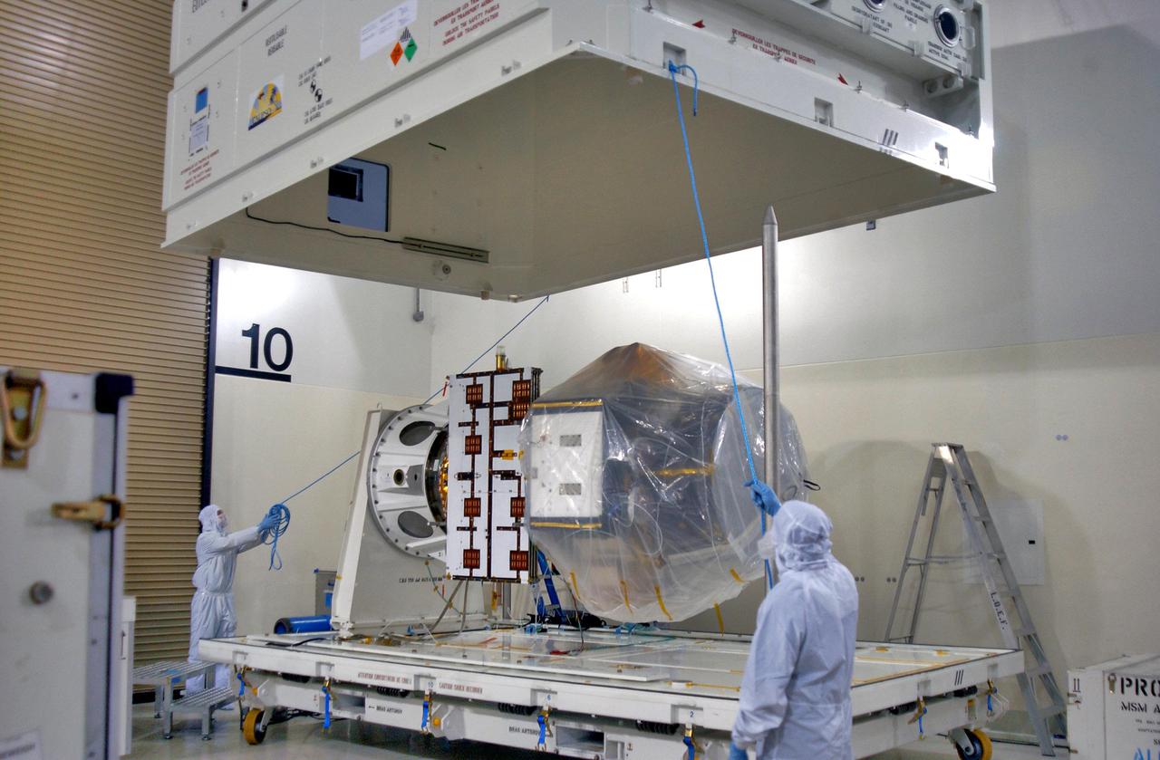KENNEDY SPACE CENTER, FLA. - Inside the Astrotech Payload Processing Facility on Vandenberg Air Force Base in California, the cover of the shipping container is lifted away from the newly arrived Cloud-Aerosol Lidar and Infrared Pathfinder Satellite Observation (CALIPSO). CALIPSO will fly in combination with the CloudSat satellite to provide never-before-seen 3-D perspectives of how clouds and aerosols form, evolve, and affect weather and climate. CALIPSO and CloudSat will join three other satellites in orbit to enhance understanding of climate systems. The launch date for CALIPSO_CloudSat is no earlier than Aug. 22.