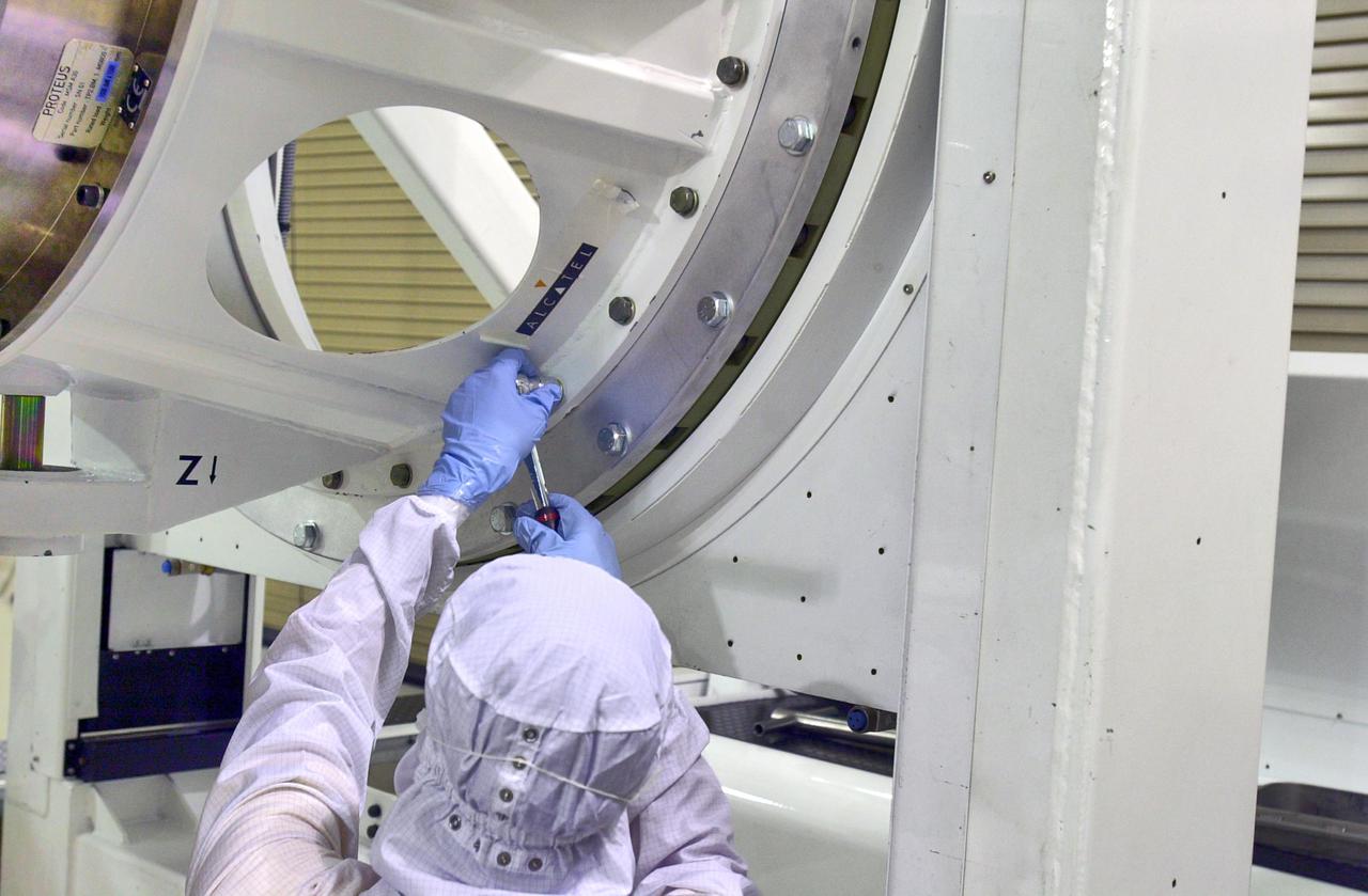 KENNEDY SPACE CENTER, FLA. - Inside the Astrotech Payload Processing Facility on Vandenberg Air Force Base in California, workers make adjustments on the tilt dolly before attempting to raise the Cloud-Aerosol Lidar and Infrared Pathfinder Satellite Observation (CALIPSO) spacecraft to vertical. CALIPSO will be moved to a workstand. It will undergo state-of-health checks, and electrical ground-support equipment testing. CALIPSO will fly in combination with the CloudSat satellite to provide never-before-seen 3-D perspectives of how clouds and aerosols form, evolve, and affect weather and climate. CALIPSO and CloudSat will join three other satellites in orbit to enhance understanding of climate systems. The launch date for CALIPSO_CloudSat is no earlier than Aug. 22.