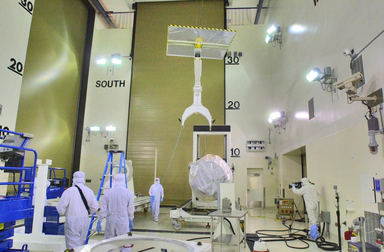 KENNEDY SPACE CENTER, FLA. - Inside the Astrotech Payload Processing Facility on Vandenberg Air Force Base in California, workers remove a piece of equipment used to help attach the Cloud-Aerosol Lidar and Infrared Pathfinder Satellite Observation (CALIPSO) spacecraft to a tilt dolly. CALIPSO will be moved to a workstand. It will undergo state-of-health checks, and electrical ground-support equipment testing. CALIPSO will fly in combination with the CloudSat satellite to provide never-before-seen 3-D perspectives of how clouds and aerosols form, evolve, and affect weather and climate. CALIPSO and CloudSat will join three other satellites in orbit to enhance understanding of climate systems. The launch date for CALIPSO_CloudSat is no earlier than Aug. 22.