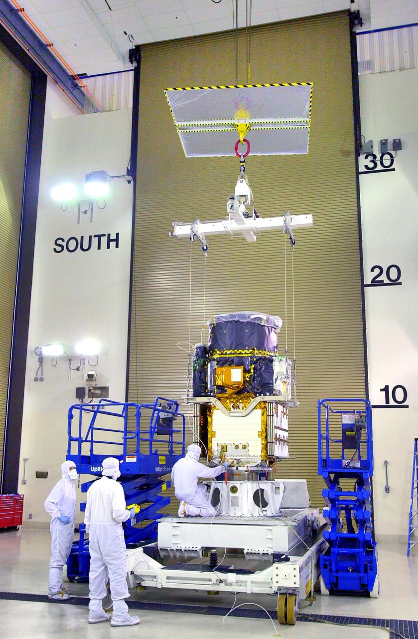 KENNEDY SPACE CENTER, FLA. - Inside the Astrotech Payload Processing Facility on Vandenberg Air Force Base in California, an overhead crane is attached to the Cloud-Aerosol Lidar and Infrared Pathfinder Satellite Observation (CALIPSO) spacecraft. CALIPSO will be lifted and transferred to a workstand. CALIPSO will undergo state-of-health checks, and electrical ground-support equipment testing. CALIPSO will fly in combination with the CloudSat satellite to provide never-before-seen 3-D perspectives of how clouds and aerosols form, evolve, and affect weather and climate. CALIPSO and CloudSat will join three other satellites in orbit to enhance understanding of climate systems. The launch date for CALIPSO_CloudSat is no earlier than Aug. 22.