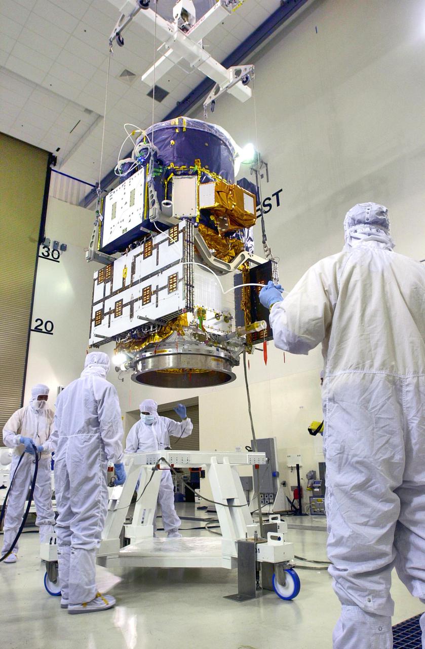 KENNEDY SPACE CENTER, FLA. - Inside the Astrotech Payload Processing Facility on Vandenberg Air Force Base in California, workers surround the Cloud-Aerosol Lidar and Infrared Pathfinder Satellite Observation (CALIPSO) spacecraft as it is lowered toward a workstand. CALIPSO will undergo state-of-health checks, and electrical ground-support equipment testing. CALIPSO will fly in combination with the CloudSat satellite to provide never-before-seen 3-D perspectives of how clouds and aerosols form, evolve, and affect weather and climate. CALIPSO and CloudSat will join three other satellites in orbit to enhance understanding of climate systems. The launch date for CALIPSO_CloudSat is no earlier than Aug. 22.