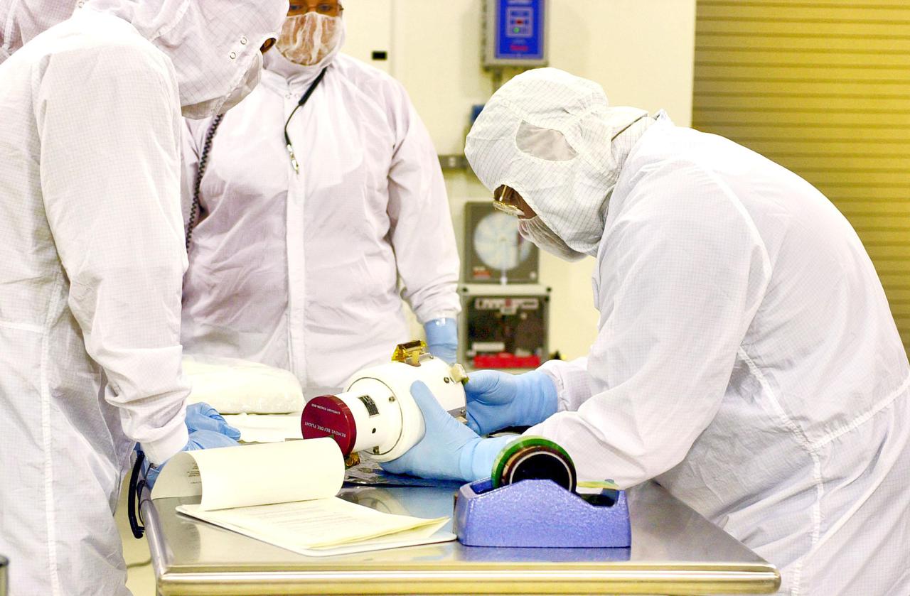 KENNEDY SPACE CENTER, FLA. - Inside the Astrotech Payload Processing Facility on Vandenberg Air Force Base in California, workers prepare a Wide Field Camera for installation on the Cloud-Aerosol Lidar and Infrared Pathfinder Satellite Observation (CALIPSO) spacecraft. CALIPSO will fly in combination with the CloudSat satellite to provide never-before-seen 3-D perspectives of how clouds and aerosols form, evolve, and affect weather and climate. CALIPSO and CloudSat will join three other satellites in orbit to enhance understanding of climate systems. The launch date for CALIPSO_CloudSat is no earlier than Aug. 22.