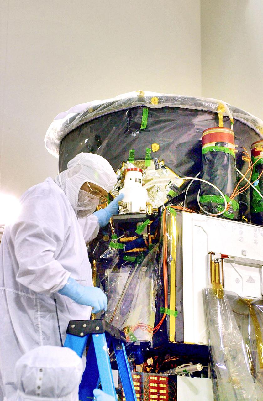KENNEDY SPACE CENTER, FLA. - Inside the Astrotech Payload Processing Facility on Vandenberg Air Force Base in California, a worker installs the Wide Field Camera on the Cloud-Aerosol Lidar and Infrared Pathfinder Satellite Observation (CALIPSO) spacecraft. CALIPSO will fly in combination with the CloudSat satellite to provide never-before-seen 3-D perspectives of how clouds and aerosols form, evolve, and affect weather and climate. CALIPSO and CloudSat will join three other satellites in orbit to enhance understanding of climate systems. The launch date for CALIPSO_CloudSat is no earlier than Aug. 22.