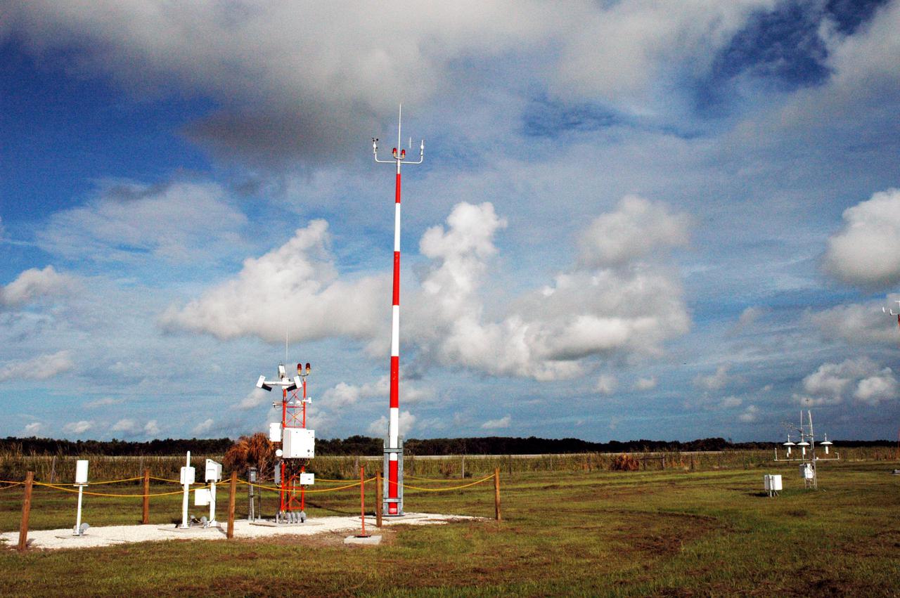 KENNEDY SPACE CENTER, FLA. -  The NOAA (National Oceanic and Atmospheric Administration) weather station, seen here at the Shuttle Landing Facility’s midfield on NASA’s Kennedy Space Center in Florida, has a new neighbor. A climate-observing network that will drastically improve the nation's awareness of how weather impacts our lives has been established at the site. NASA, NOAA and the U.S. Air Force will work together on the U.S. Climate Reference Network, which will examine climate trends and change throughout the nation and its surrounding regions for the next 50 years.  Instruments that are being provided include a solar radiation measuring device and an infrared surface temperature instrument.  This gives Kennedy a unique opportunity to compare its sensor system with the NOAA site that is approximately 100 feet away.