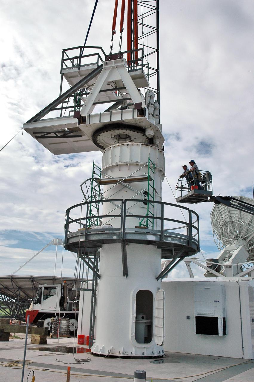 KENNEDY SPACE CENTER, FLA. - On a radar site on North Merritt Island, Fla., part of the structure for the support base for a 50-foot C-band radar antenna is put in position.The radar will be used for Shuttle missions to track the launches and observe possible debris coming from the Shuttle.   It will be used for the first time on STS-114. The launch window for the first Return to Flight mission is July 13 to July 31.