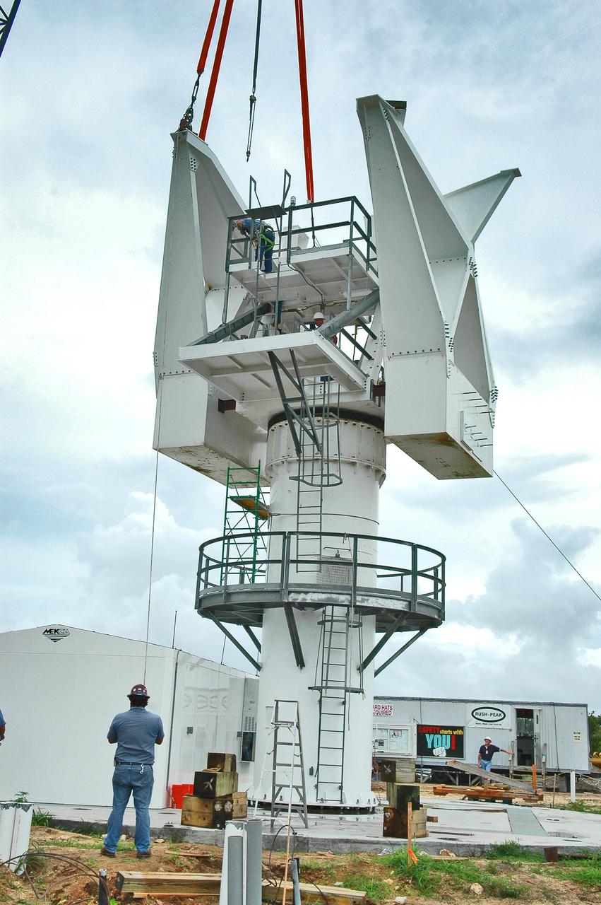 KENNEDY SPACE CENTER, FLA. - At a radar site on North Merritt Island, Fla., the second counterweight (left side) is moved into place on the support structure for a 50-foot C-band radar antenna dish. The radar will be used for Shuttle missions to track the launches and observe possible debris coming from the Shuttle.  It will be used for the first time on STS-114. The launch window for the first Return to Flight mission is July 13 to July 31.