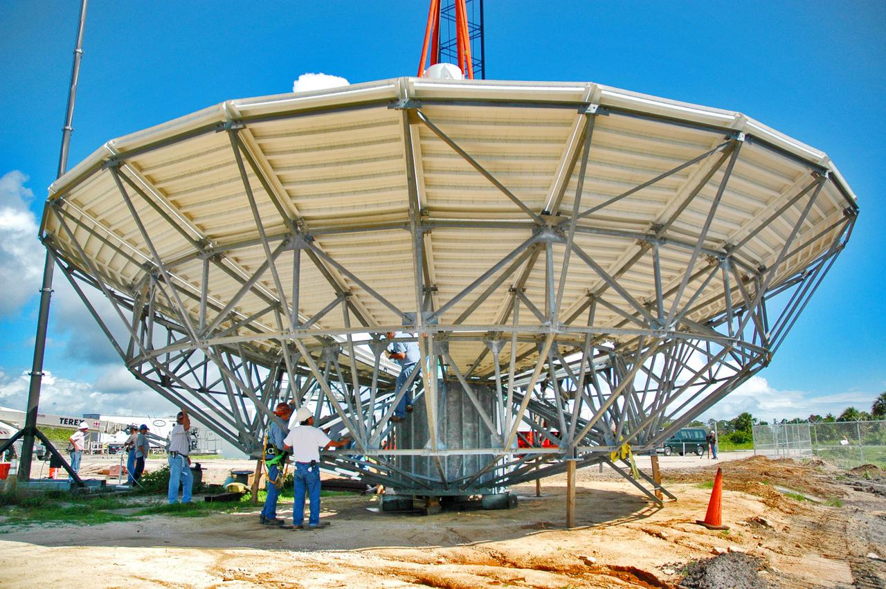 KENNEDY SPACE CENTER, FLA. - At a radar site on North Merritt Island, Fla., the 50-foot C-band radar antenna dish is prepared to be lifted onto the top of a support structure.  The radar will be used for Shuttle missions to track the launches and observe possible debris coming from the Shuttle.  It will be used for the first time on STS-114. The launch window for the first Return to Flight mission is July 13 to July 31.
