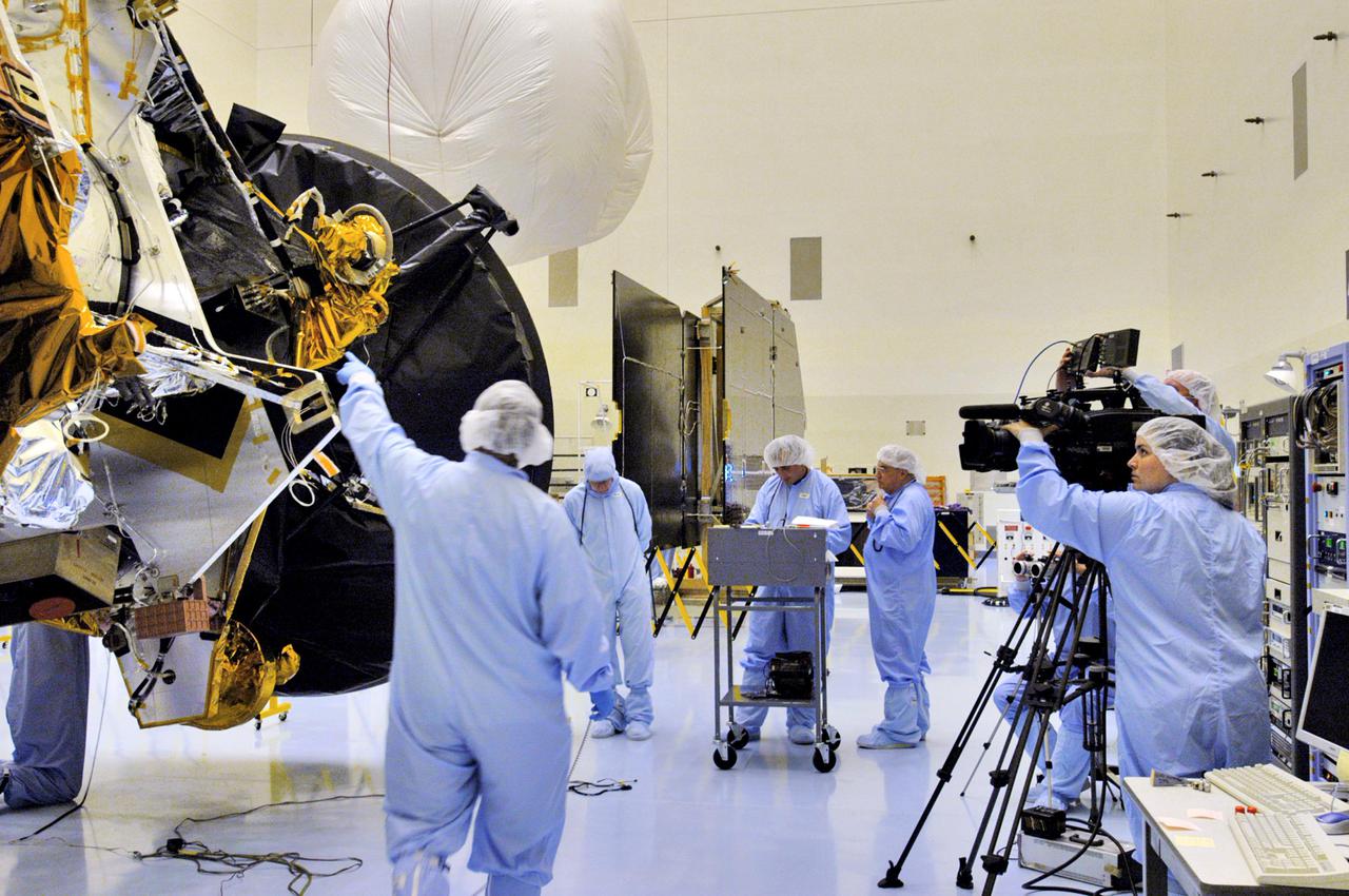 KENNEDY SPACE CENTER, FLA. - In the Payload Hazardous Servicing Facility at NASA’s Kennedy Space Center, workers from Lockheed Martin test the installation of the high-gain antenna on the Mars Reconnaissance Orbiter (MRO). After solar array installation, the MRO will be transported to the Vertical Installation Facility in late July. It will join the Atlas V for the final phase of launch preparations. The spacecraft is then scheduled to undergo a functional test, and a final week of integrated testing and closeouts. The MRO was built by Lockheed Martin for the Jet Propulsion Laboratory in California. It is the next major step in Mars exploration and scheduled for launch from Cape Canaveral Air Force Station in a window opening Aug. 10. The MRO is an important next step in fulfilling NASA’s vision of space exploration and ultimately sending human explorers to Mars and beyond.