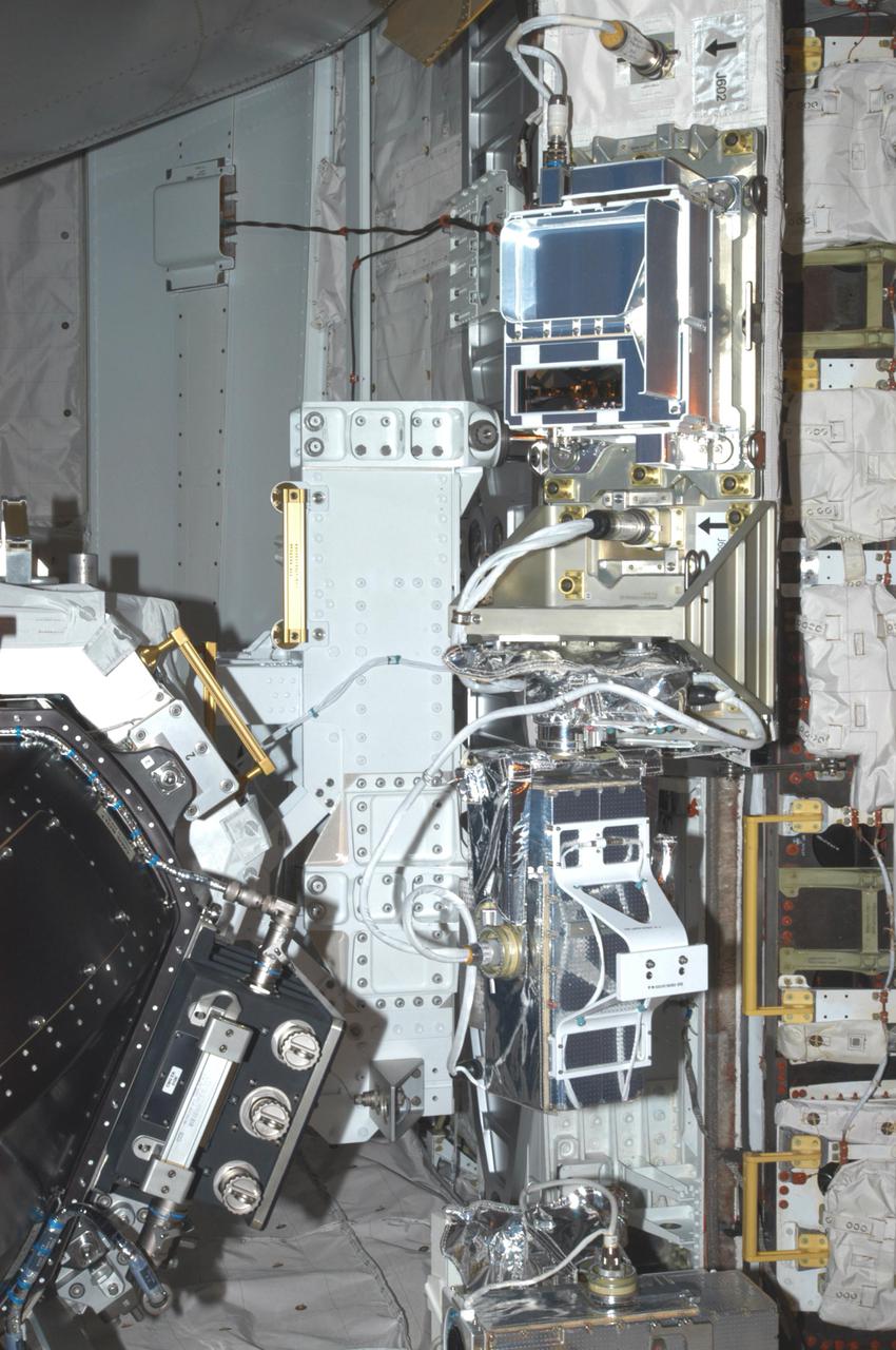 KENNEDY SPACE CENTER, FLA. - At Launch Pad 39B, the Orbiter Boom Sensor System (OBSS) sensor package is viewed before the orbiter's payload bay doors are closed for launch. Payload bay door closure is a significant milestone in the preparations of Discovery for the first Return to Flight mission, STS-114.  This sensor package will provide surface area and depth defect inspection for all the surfaces of the orbiter. It includes an intensified television camera (ITVC) and a laser dynamic range imager, which are mounted on a pan and tilt unit, and a laser camera system (LCS) mounted on a stationary bracket. The package is part of the new safety measures added for all future Space Shuttle missions. During its 12-day mission, Discovery’s seven-person crew will test new hardware and techniques to improve Shuttle safety, as well as deliver supplies to the International Space Station. Discovery’s payloads include the Multi-Purpose Logistics Module Raffaello, the Lightweight Multi-Purpose Experiment Support Structure Carrier (LMC), and the External Stowage Platform-2 (ESP-2). Raffaello will deliver supplies to the International Space Station including food, clothing and research equipment. The LMC supports a replacement Control Moment Gyroscope and a tile repair sample box. The ESP-2 is outfitted with replacement parts. Launch of mission STS-114 was set for July 13 at the conclusion of the Flight Readiness Review yesterday.