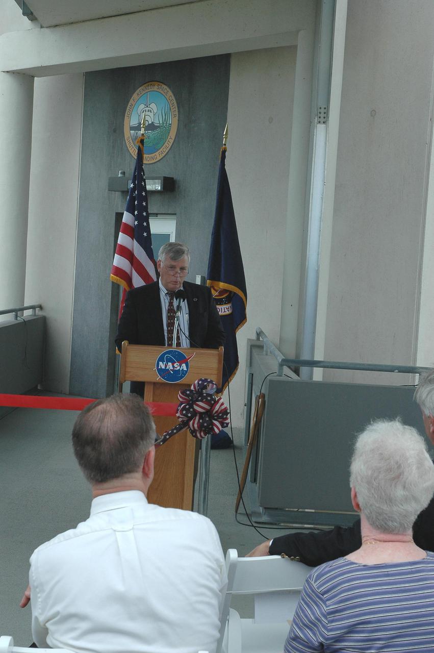 KENNEDY SPACE CENTER, FLA. - At the Shuttle Landing Facility on NASA’s Kennedy Space Center, KSC Director Jim Kennedy talks to attendees at the ribbon-cutting ceremony for the new NASA Air Traffic Control Tower.  The dedication took place in the SLF’s new media facilities, which were built for the Return to Flight mission STS-114 and the landing of Shuttle Discovery. The facilities are co-located with the new control tower. The dedication and ribbon cutting were held at the base of the tower and included Center Director Jim Kennedy, Space Gateway Support President William A. Sample, External Relations Director Lisa Malone, Center Operations Director Scott D. Kerr, and KSC Safety Aviation Officer Albert E. Taff.  The structure rises 110 feet over the midpoint of the runway and offers air traffic controllers a magnificent 360-degree view of Kennedy Space Center, Cape Canaveral Air Force Station and north Brevard County. It replaces the small, portable tower installed at the edge of the runway in 1986. The new control tower will manage all landings and departures from the SLF, including air traffic within the Kennedy Space Center-Cape Canaveral restricted airspace.  The facility provides a 24-hour weather-observing facility providing official hourly weather observations for the SLF and the Cape Canaveral vicinity, including special observations for all launches and landings. State-of-the-art, weather-observing equipment has been installed for Space Shuttle landings and for serving conventional aircraft landing at the SLF. At this location, weather observers will have a multi-directional view of the weather conditions at the runway and Launch Complex 39.
