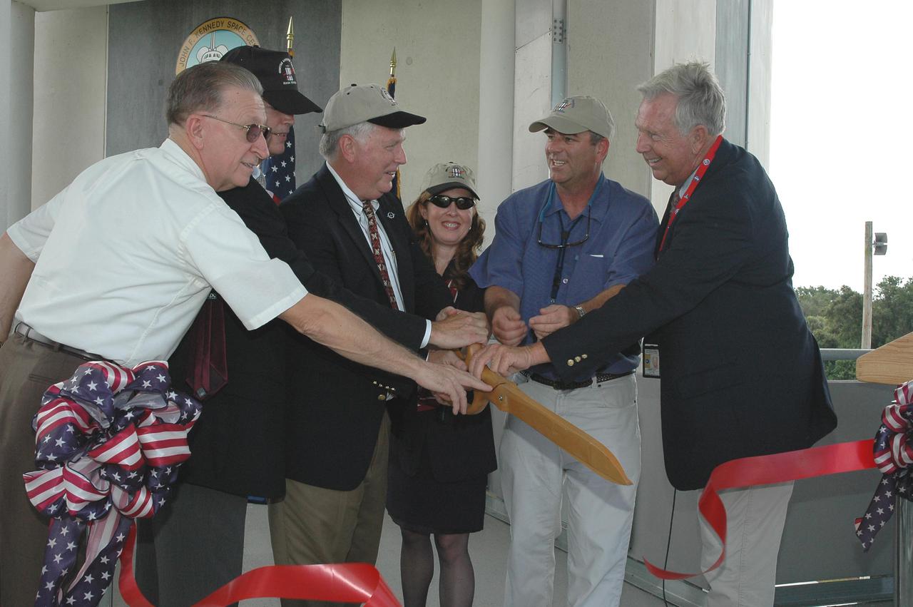 KENNEDY SPACE CENTER, FLA. - At the Shuttle Landing Facility on NASA’s Kennedy Space Center, a ribbon-cutting dedicated the new NASA Air Traffic Control Tower.  From left are James H. Jones, Space Gateway Support President William A. Sample, Center Director Jim Kennedy, External Relations Director Lisa Malone, Center Operations Director Scott D. Kerr, and KSC Safety Aviation Officer Albert E. Taff.   The structure rises 110 feet over the midpoint of the runway and offers air traffic controllers a magnificent 360-degree view of Kennedy Space Center, Cape Canaveral Air Force Station and north Brevard County. It replaces the small, portable tower installed at the edge of the runway in 1986. The new control tower will manage all landings and departures from the SLF, including air traffic within the Kennedy Space Center-Cape Canaveral restricted airspace.  The facility provides a 24-hour weather-observing facility providing official hourly weather observations for the SLF and the Cape Canaveral vicinity, including special observations for all launches and landings. State-of-the-art, weather-observing equipment has been installed for Space Shuttle landings and for serving conventional aircraft landing at the SLF. At this location, weather observers will have a multi-directional view of the weather conditions at the runway and Launch Complex 39.