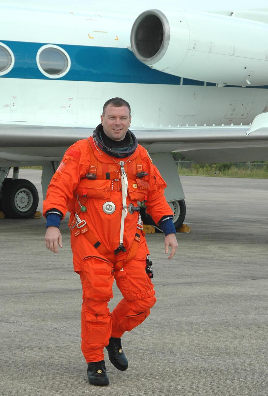 KENNEDY SPACE CENTER, FLA. -- James Kelly, pilot on Return to Flight mission STS-114, walks away from the Shuttle Training Aircraft (STA) at the Shuttle Landing Facility on NASA’s Kennedy Space Center. He and Mission Commander Eileen Collins are practicing landing the orbiter using the STA, which is a modified Grumman American Aviation-built Gulf Stream II executive jet that was modified to simulate an orbiter’s cockpit, motion and visual cues, and handling qualities. In flight, the STA duplicates the orbiter’s atmospheric descent trajectory from approximately 35,000 feet altitude to landing on a runway. Because the orbiter is unpowered during re-entry and landing, its high-speed glide must be perfectly executed the first time.  Mission STS-114 is scheduled to launch aboard Space Shuttle Discovery with a crew of seven on July 13 at 3:51 p.m. from Launch Pad 39B.