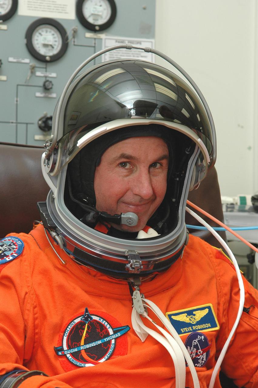 KENNEDY SPACE CENTER, FLA. -- In the Operations and Checkout Building at NASA’s Kennedy Space Center, Return to Flight STS-114 Mission Specialist Stephen Robinson checks the fit of his launch and entry suit and helmet. This is Robinson’s third Shuttle launch. There are two days to the launch of Space Shuttle Discovery scheduled for 3:51 p.m. July 13. This launch is the 114th Space Shuttle flight and is scheduled to last about 12 days with a planned KSC landing at about 11:06 a.m. EDT on July 25.