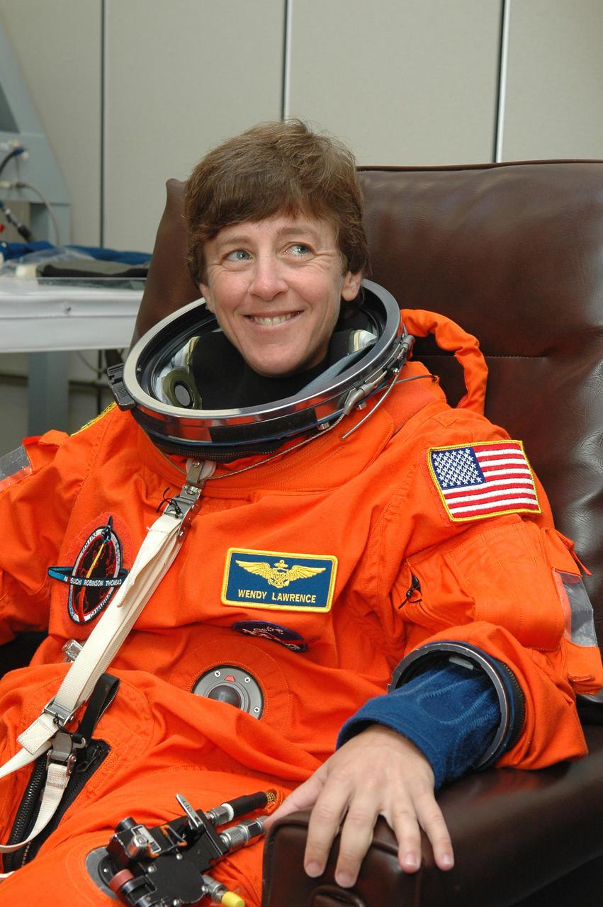 KENNEDY SPACE CENTER, FLA. -- In the Operations and Checkout Building at NASA’s Kennedy Space Center, Return to Flight STS-114 Mission Specialist Wendy Lawrence checks the fit of her launch and entry suit.  This is Lawrence’s fourth Shuttle flight.  There are two days to the launch of Space Shuttle Discovery scheduled for 3:51 p.m. July 13.  This launch is the 114th Space Shuttle flight and is scheduled to last about 12 days with a planned KSC landing at about 11:06 a.m. EDT on July 25.