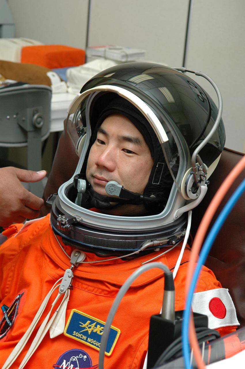 KENNEDY SPACE CENTER, FLA. -- In the Operations and Checkout Building at NASA’s Kennedy Space Center, Return to Flight STS-114 Mission Specialist Soichi Noguchi checks the fit of his launch and entry suit and helmet.  This is Noguchi’s first Shuttle flight.  He represents the Japan Aerospace Exploration Agency (JAXA).  There are two days to the launch of Space Shuttle Discovery scheduled for 3:51 p.m. July 13.  This launch is the 114th Space Shuttle flight and is scheduled to last about 12 days with a planned KSC landing at about 11:06 a.m. EDT on July 25.