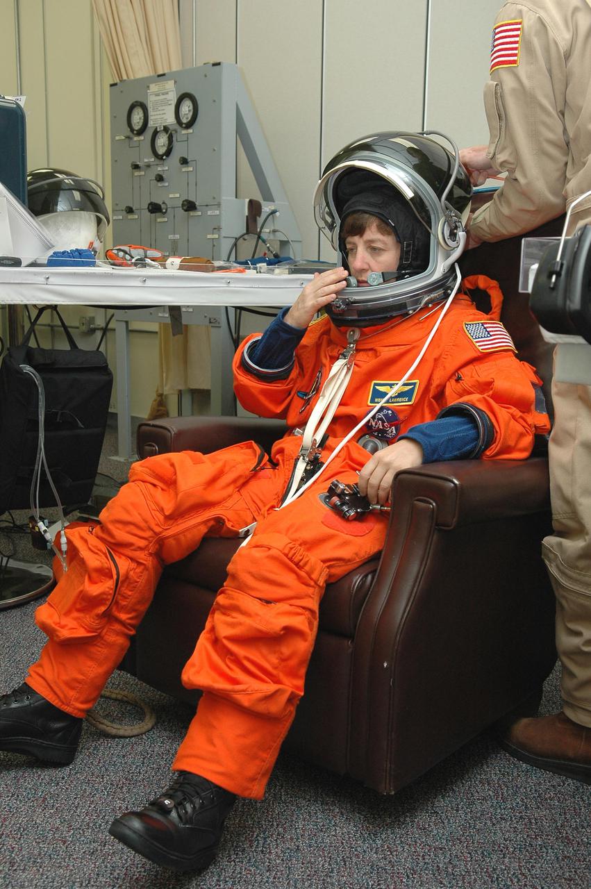 KENNEDY SPACE CENTER, FLA. -- In the Operations and Checkout Building at NASA’s Kennedy Space Center, Return to Flight STS-114 Mission Specialist Wendy Lawrence checks the fit of her launch and entry suit and helmet.  There are two days to the launch of Space Shuttle Discovery scheduled for 3:51 p.m. July 13.  This launch is the 114th Space Shuttle flight and is scheduled to last about 12 days with a planned KSC landing at about 11:06 a.m. EDT on July 25.