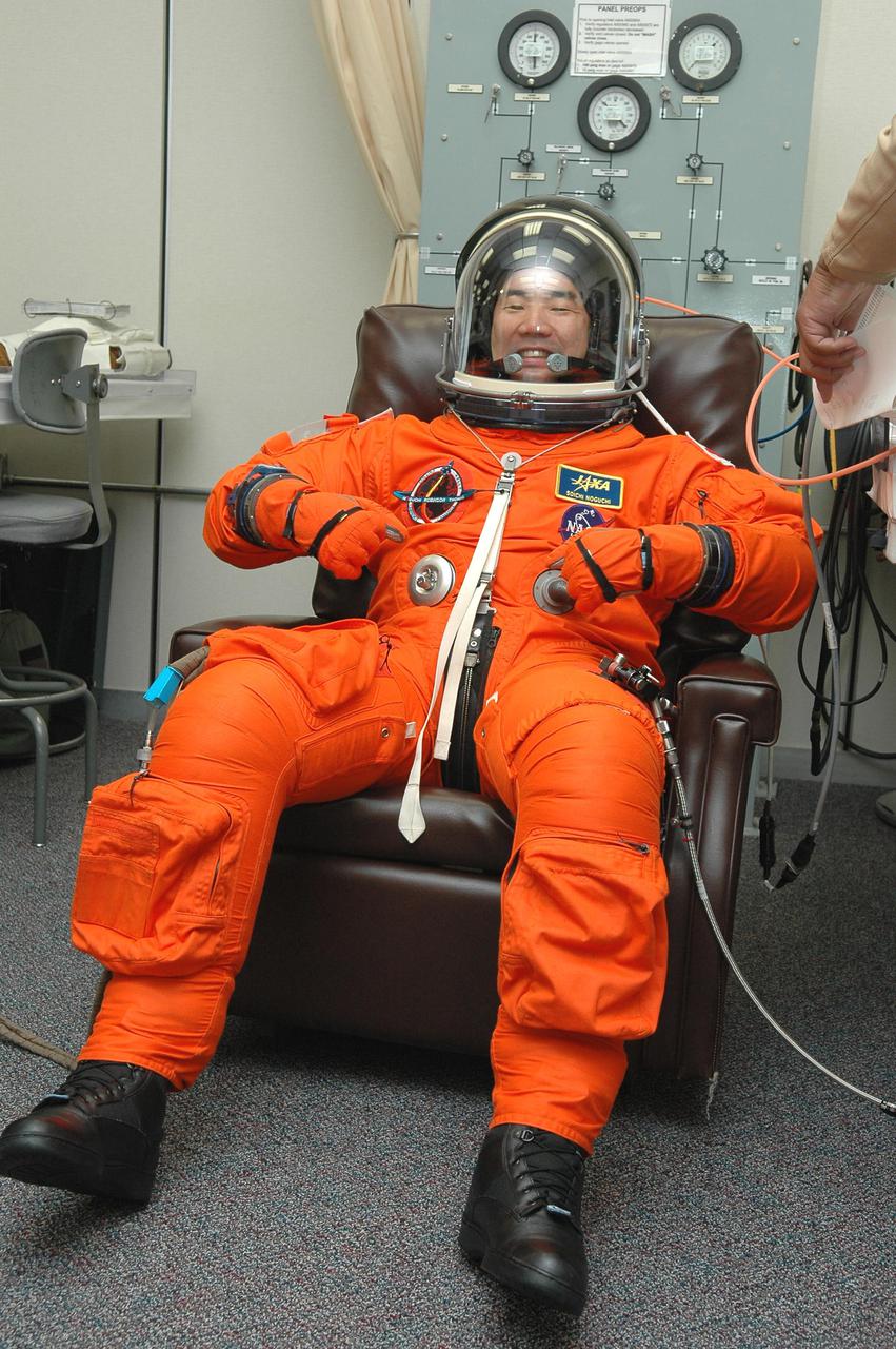 KENNEDY SPACE CENTER, FLA. -- In the Operations and Checkout Building at NASA’s Kennedy Space Center, Return to Flight STS-114 Mission Specialist Soichi Noguchi checks the fit of his launch and entry suit and helmet.  This is Noguchi’s first Shuttle flight.  He represents the Japan Aerospace Exploration Agency (JAXA).  There are two days to the launch of Space Shuttle Discovery scheduled for 3:51 p.m. July 13. This launch is the 114th Space Shuttle flight and is scheduled to last about 12 days with a planned KSC landing at about 11:06 a.m. EDT on July 25.