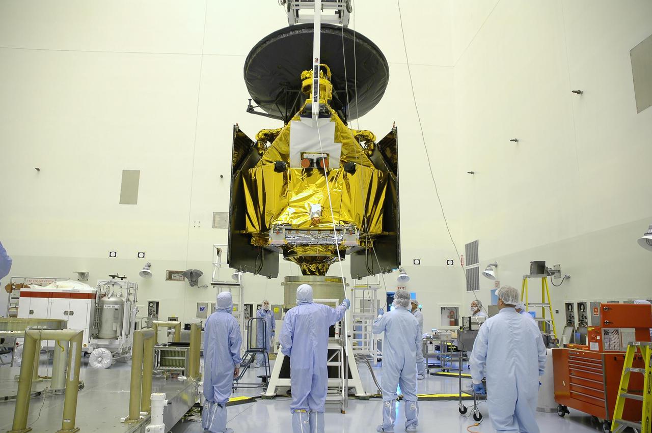 KENNEDY SPACE CENTER, FLA. -- In the Payload Hazardous Servicing Facility, workers from Lockheed Martin stand nearby as the suspended Mars Reconnaissance Orbiter (MRO) is lowered toward the spin balance machine for testing. In late July, the MRO will be transported to the Vertical Installation Facility. It will join the Atlas V for the final phase of launch preparations. The spacecraft is then scheduled to undergo a functional test, and a final week of integrated testing and closeouts. The MRO was built by Lockheed Martin for the Jet Propulsion Laboratory in California. It is the next major step in Mars exploration and scheduled for launch from Cape Canaveral Air Force Station in a window opening Aug. 10. The MRO is an important next step in fulfilling NASA’s vision of space exploration and ultimately sending human explorers to Mars and beyond.
