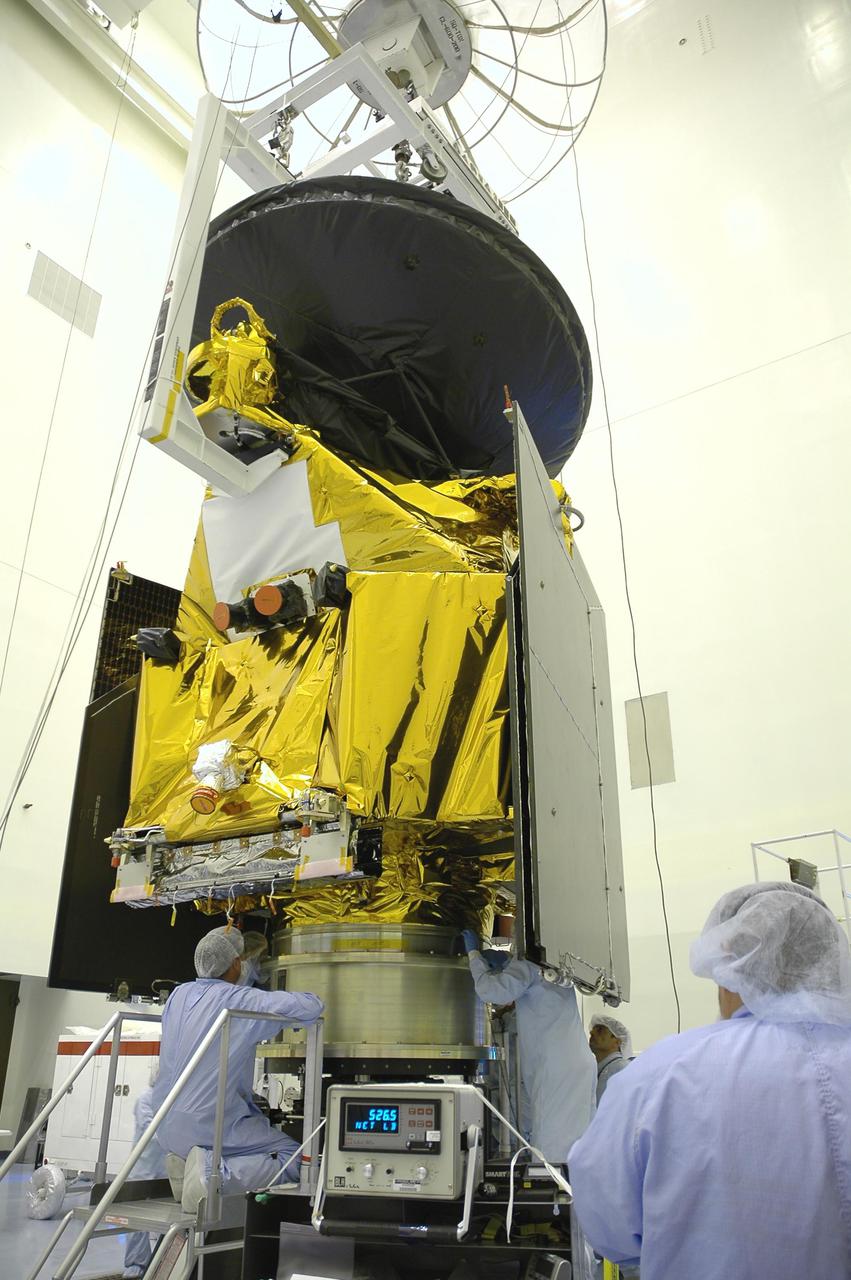 KENNEDY SPACE CENTER, FLA. -- In the Payload Hazardous Servicing Facility, workers from Lockheed Martin begin securing the Mars Reconnaissance Orbiter (MRO) onto the spin balance machine for testing. In late July, the MRO will be transported to the Vertical Installation Facility. It will join the Atlas V for the final phase of launch preparations. The spacecraft is then scheduled to undergo a functional test, and a final week of integrated testing and closeouts. The MRO was built by Lockheed Martin for the Jet Propulsion Laboratory in California. It is the next major step in Mars exploration and scheduled for launch from Cape Canaveral Air Force Station in a window opening Aug. 10. The MRO is an important next step in fulfilling NASA’s vision of space exploration and ultimately sending human explorers to Mars and beyond.
