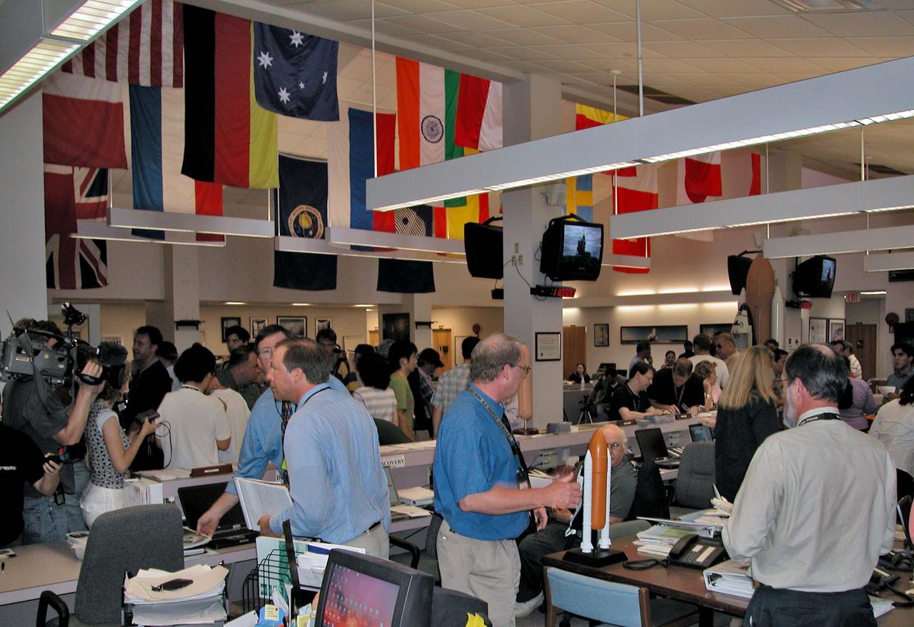 KENNEDY SPACE CENTER, FLA. -  NASA spokesmen prepare to answer questions from news media representatives gathered in the NASA Newsroom to cover the countdown for the launch of Space Shuttle Discovery on Return to Flight mission STS-114.  Liftoff is planned for 3:51 p.m. EDT July 13.  During its 12-day mission, Discovery’s seven-person crew will test new hardware and techniques to improve Shuttle safety, as well as deliver supplies to the International Space Station.