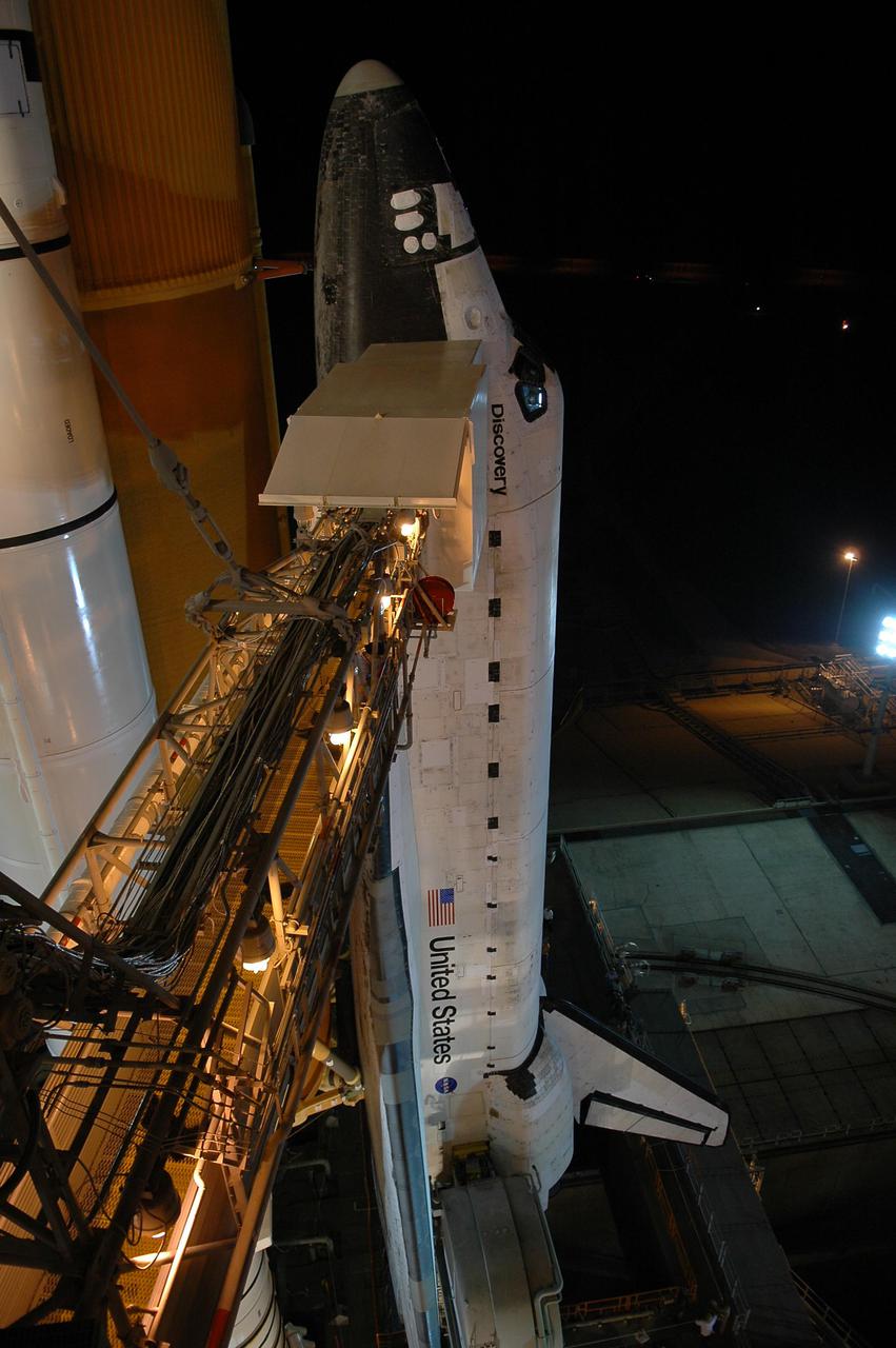 KENNEDY SPACE CENTER, FLA. -  Following rollback of the Rotating Service Structure, the orbiter access arm is able to be extended to Space Shuttle Discovery.  The arm provides access into Discovery through the White Room, where the astronauts are checked by the closeout crew.  Discovery is scheduled to launch on the historic Return to Flight mission STS-114 at 3:51 p.m. July 13 with a crew of seven.  The payload includes the External Stowage Platform-2, equipped with spare part assemblies, and a replacement Control Moment Gyroscope contained in the Lightweight Multi-Purpose Experiment Support Structure.  The astronauts will make three spacewalks, including one to practice repair techniques for the Shuttle’s heat shield and one to install the new gyroscope. This is the 114th Space Shuttle flight and the 31st for Discovery.  The 12-day mission is expected to end with touchdown at NASA Kennedy Space Center’s Shuttle Landing Facility at 11:06 a.m. July 25.