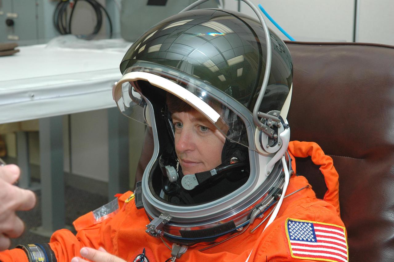 KENNEDY SPACE CENTER, FLA. - In the Operations and Checkout Building at NASA’s Kennedy Space Center, the Return to Flight STS-114 crew is suiting up in preparation for launch aboard Space Shuttle Discovery.  Mission Specialist Wendy Lawrence is securing her gloves and helmet.  The crew is scheduled to launch on this historic mission at 3:51 p.m. EDT today from Launch Pad 39B.  It is the 114th Space Shuttle flight and the 31st for Discovery.  The 12-day mission is expected to end with touchdown at the Shuttle Landing Facility at 11:06 a.m. July 25.