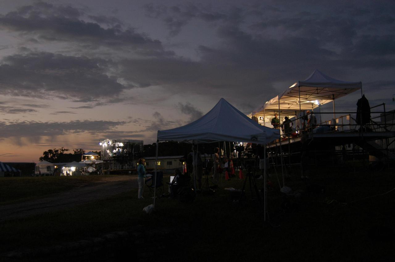 KENNEDY SPACE CENTER, FLA. - Dawn creeps over the horizon revealing shadows of the media tents and trucks at the NASA News Center. The scene is the calm before the storm of journalists and photographers who have descended upon KSC to capture the Return to Flight mission STS-114 to the International Space Station. This is the first Space Shuttle flight since the loss of Columbia, STS-107, on Feb. 1, 2003. Launch is scheduled for 3:51 p.m. EDT from Launch Pad 39B. The 12-day mission is expected to end with touchdown at NASA Kennedy Space Center’s Shuttle Landing Facility at 11:06 a.m. July 25.