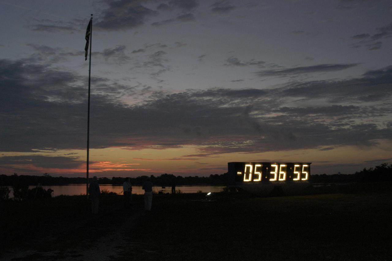 KENNEDY SPACE CENTER, FLA. -  The countdown clock at NASA Kennedy Space Center glows in the dark as a hint of dawn creeps over the horizon.  The clock counts down the hours until launch of Space Shuttle Discovery on Return to Flight mission STS-114 to the International Space Station.  This is the first Space Shuttle flight since the loss of Columbia, STS-107, on Feb. 1, 2003.  Launch is scheduled for 3:51 p.m. EDT from Launch Pad 39B. The 12-day mission is expected to end with touchdown at NASA Kennedy Space Center’s Shuttle Landing Facility at 11:06 a.m. July 25.