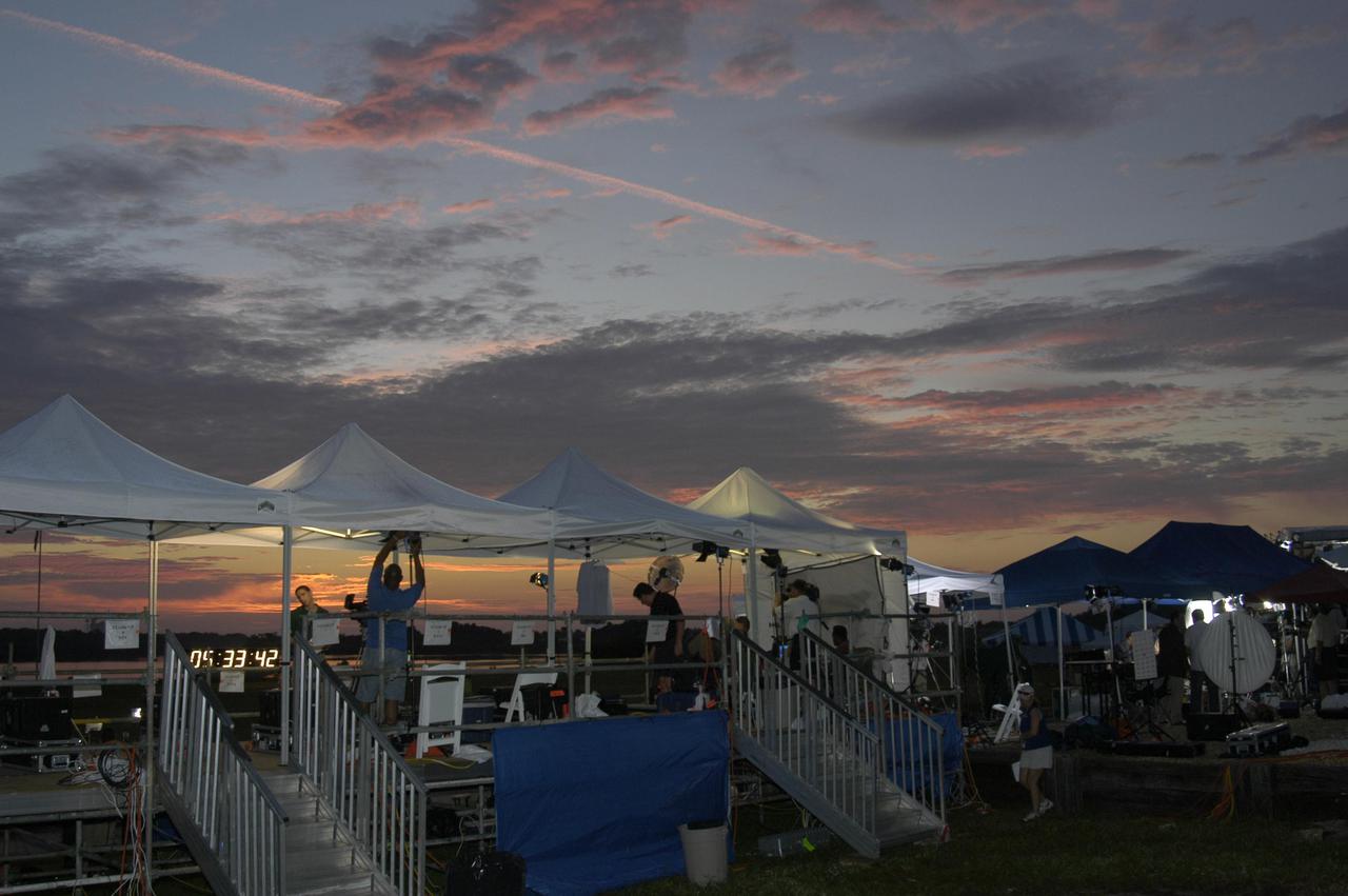 KENNEDY SPACE CENTER, FLA. - Dawn creeps over the horizon revealing canopies going up for some of the media in preparation for launch coverage at NASA Kennedy Space Center. Thousands of journalists, photographers and television media have descended upon KSC to capture the Return to Flight mission STS-114 to the International Space Station. This is the first Space Shuttle flight since the loss of Columbia, STS-107, on Feb. 1, 2003. Launch is scheduled for 3:51 p.m. EDT from Launch Pad 39B. The 12-day mission is expected to end with touchdown at NASA Kennedy Space Center’s Shuttle Landing Facility at 11:06 a.m. July 25.