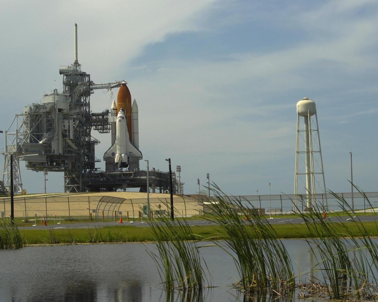 KENNEDY SPACE CENTER, FLA. - Space Shuttle Discovery remains on the launch pad at 3:51 p.m. EDT, the scheduled time of liftoff for Return to Flight mission STS-114. The launch was scrubbed due to a faulty sensor reading in the External Tank during countdown. The Mission Management Team is testing the sensor and evaluating future launch options. (Photo courtesy of Scott Andrews)