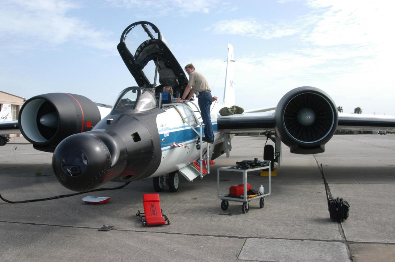 KENNEDY SPACE CENTER, FLA. -   At Patrick Air Force Base in Cocoa Beach, Fla., workers prepare the WB-57F aircraft that will take photos of Space Shuttle Discovery during its launch on Return to Flight mission STS-114.  NASA approved the development and implementation of the aircraft-based imaging system, known as the WB-57 Ascent Video Experiment (WAVE).  The WAVE provides both ascent and entry imagery and enables better observation of the Shuttle on days of heavier cloud cover and areas obscured from ground cameras by the launch exhaust plume. WAVE comprises a 32-inch-ball turret system mounted on the nose of two WB-57 aircraft. The turret houses an optical bench, providing installation of both HDTV and infrared cameras. Optics consist of an 11-inch-diameter, 4.2 meter fixed-focal-length lens. The system can be operated in both auto track and manual modes.