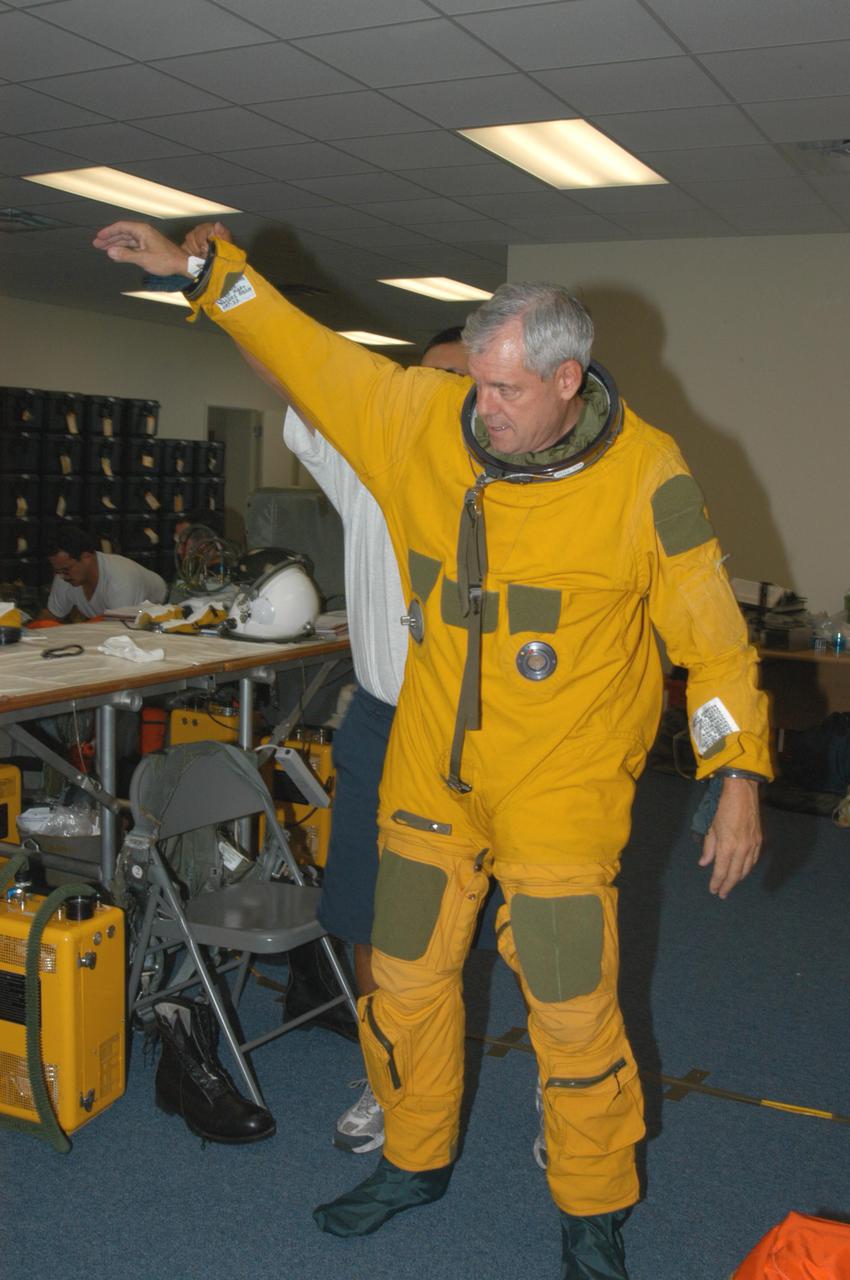 KENNEDY SPACE CENTER, FLA. -   NASA pilot Rick Hull suits up before a test flight of the WB-57F aircraft that will take photos of Space Shuttle Discovery during its launch on Return to Flight mission STS-114.  NASA approved the development and implementation of the aircraft-based imaging system, known as the WB-57 Ascent Video Experiment (WAVE).  The WAVE provides both ascent and entry imagery and enables better observation of the Shuttle on days of heavier cloud cover and areas obscured from ground cameras by the launch exhaust plume. WAVE comprises a 32-inch-ball turret system mounted on the nose of two WB-57 aircraft. The turret houses an optical bench, providing installation of both HDTV and infrared cameras. Optics consist of an 11-inch-diameter, 4.2 meter fixed-focal-length lens. The system can be operated in both auto track and manual modes.