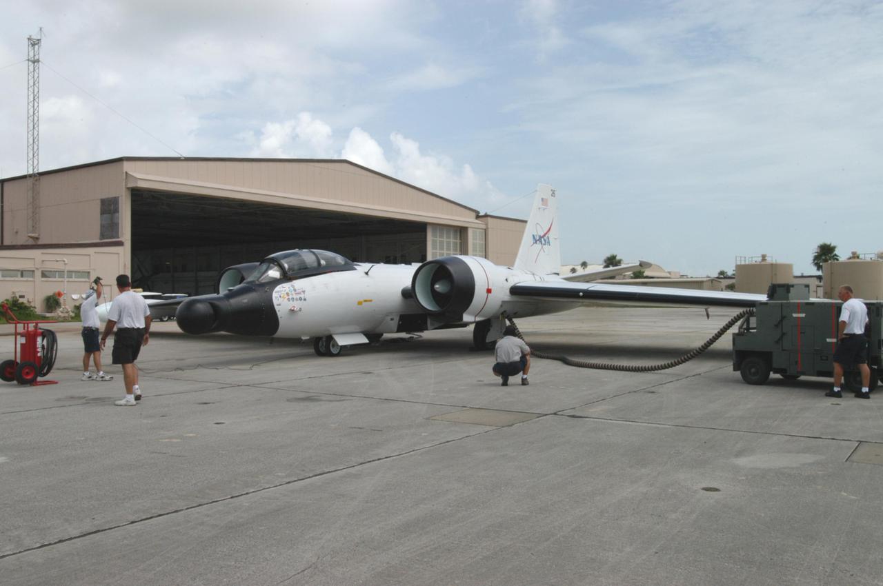 KENNEDY SPACE CENTER, FLA. -  At Patrick Air Force Base in Cocoa Beach, Fla., a WB-57F aircraft is being prepared for a practice flight.  The aircraft will take photos of Space Shuttle Discovery during its launch on Return to Flight mission STS-114.  NASA approved the development and implementation of the aircraft-based imaging system, known as the WB-57 Ascent Video Experiment (WAVE).  The WAVE provides both ascent and entry imagery and enables better observation of the Shuttle on days of heavier cloud cover and areas obscured from ground cameras by the launch exhaust plume. WAVE comprises a 32-inch-ball turret system mounted on the nose of two WB-57 aircraft. The turret houses an optical bench, providing installation of both HDTV and infrared cameras. Optics consist of an 11-inch-diameter, 4.2 meter fixed-focal-length lens. The system can be operated in both auto track and manual modes.