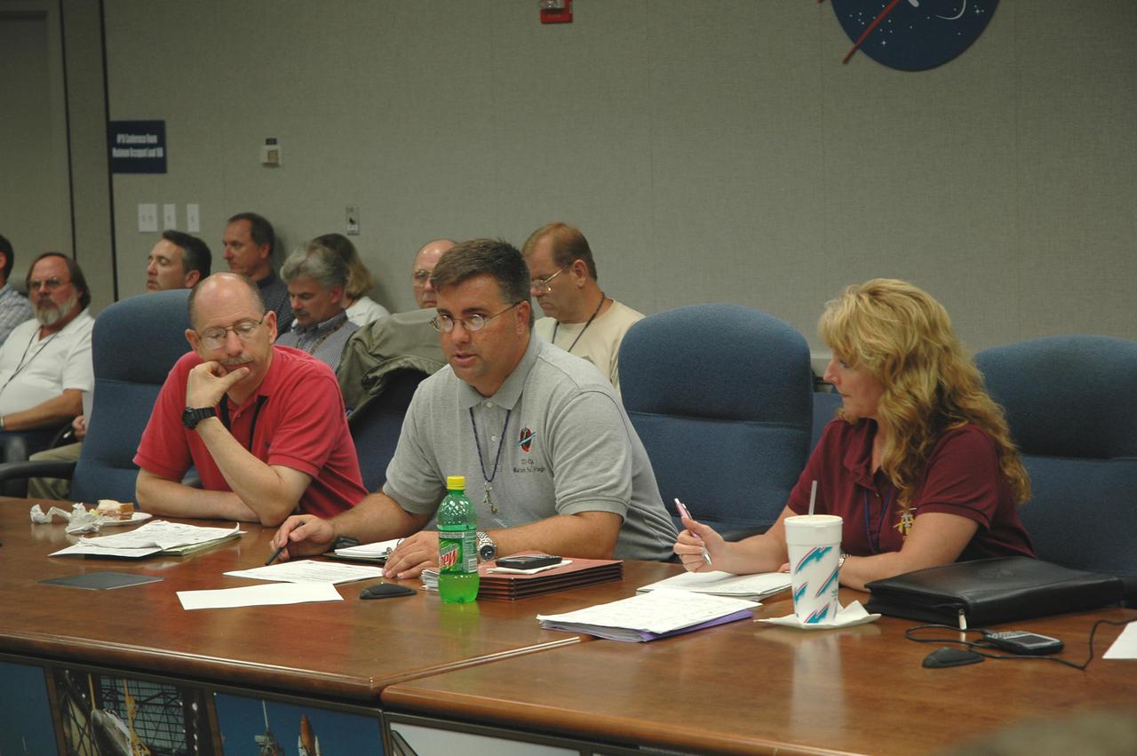 KENNEDY SPACE CENTER, FLA. -   Members of the engineering team are meeting in the Launch Control Center to review data and possible troubleshooting plans for the liquid hydrogen tank low-level fuel cut-off sensor. At left is John Muratore, manager of Systems Engineering and Integration for the Space Shuttle Program; Ed Mango, JSC deputy manager of the orbiter project office; and Carol Scott, KSC Integration Manager.  The sensor failed a routine prelaunch check during the launch countdown July 13, causing mission managers to scrub Discovery's first launch attempt. The sensor protects the Shuttle's main engines by triggering their shutdown in the event fuel runs unexpectedly low. The sensor is one of four inside the liquid hydrogen section of the External Tank (ET).