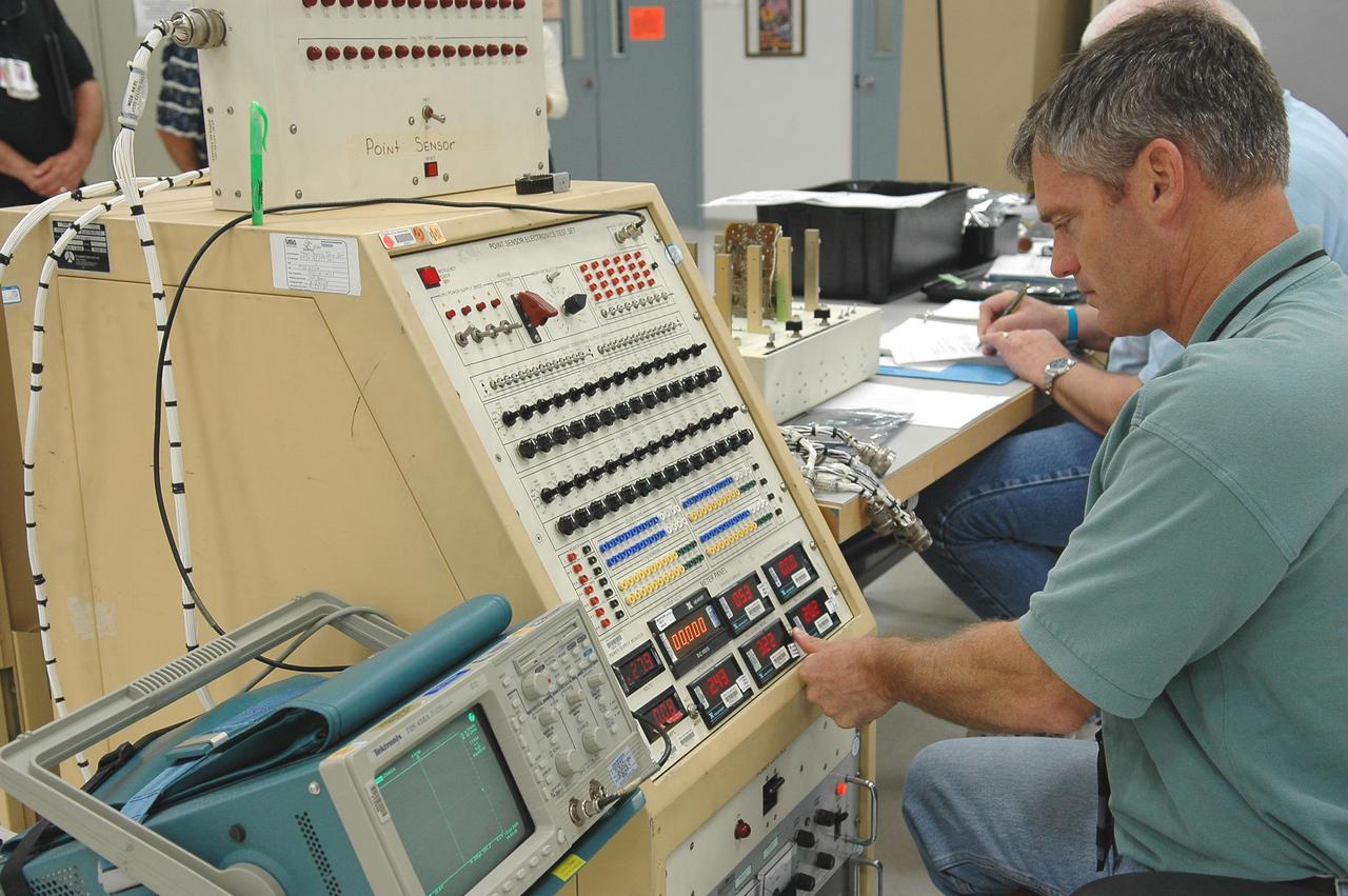 KENNEDY SPACE CENTER, FLA. -   Gary King, a test technician, helps test electronic components related to the faulty sensor readings in the liquid hydrogen tank low-level fuel cut-off sensor. The sensor failed a routine prelaunch check during the launch July 13 afternoon, causing mission managers to scrub Discovery's first launch attempt. The sensor protects the Shuttle's main engines by triggering their shutdown in the event fuel runs unexpectedly low. The sensor is one of four inside the liquid hydrogen section of the External Tank (ET).