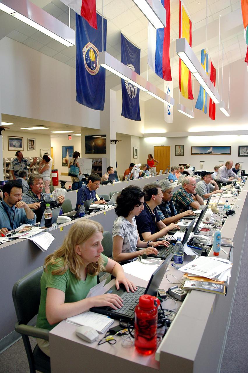KENNEDY SPACE CENTER, FLA. -    Journalists fill the work stations at the NASA News Center while others find standing room only during launch activities for Return to Flight mission STS-114.  More than a thousand media representatives from 36 states, the District of Columbia and 32 countries converged on the News Center for the historic launch.