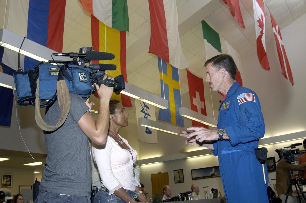 KENNEDY SPACE CENTER, FLA. -   Astronaut James Reilly is interviewed in the NASA News Center at NASA Kennedy Space Center by a television reporter during launch activities for Return to Flight mission STS-114.  Reilly has flown on two Shuttle missions, STS-89 and STS-104.  More than a thousand media representatives from 36 states, the District of Columbia and 32 countries converged on the News Center for the historic launch.
