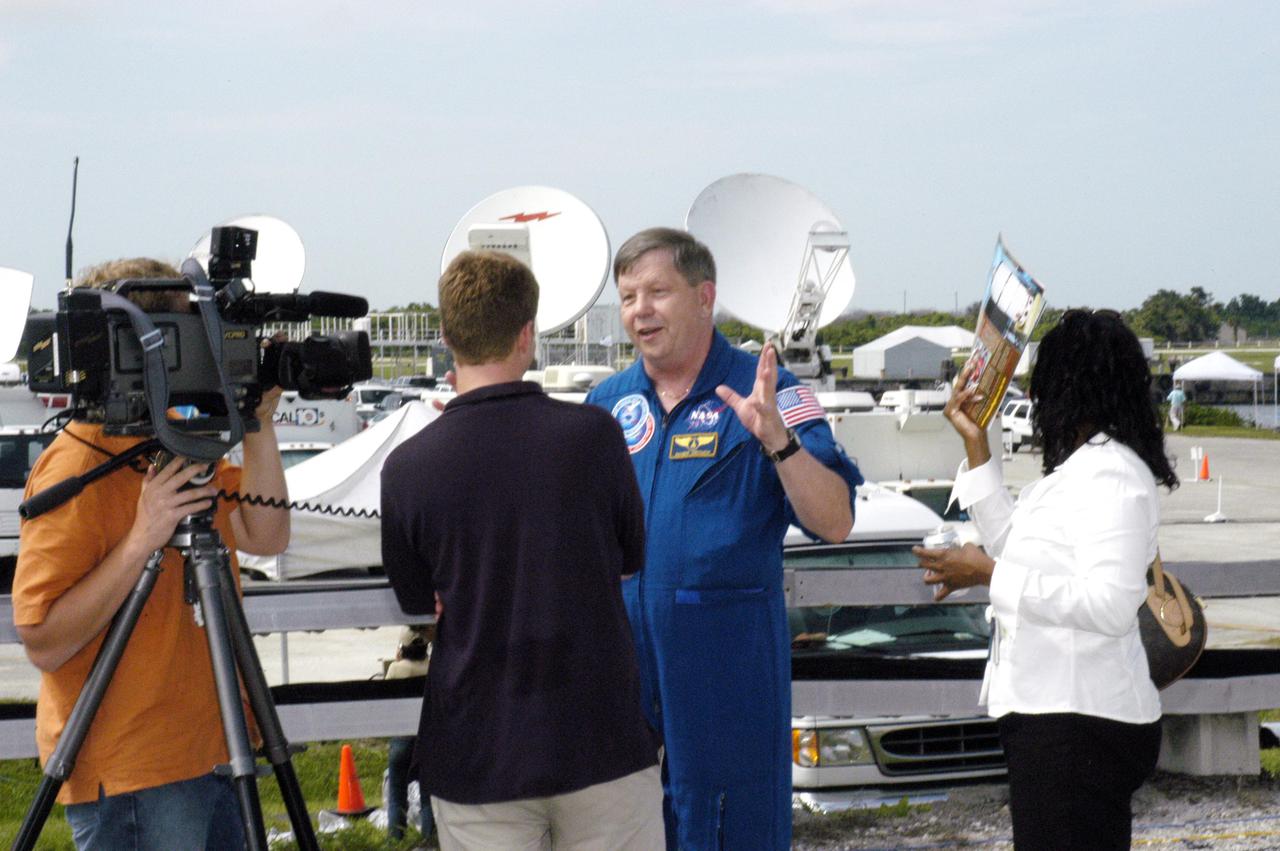 KENNEDY SPACE CENTER, FLA. -   Roger Crouch (center), a payload specialist, talks to the media prior to the launch of Space Shuttle Discovery on the historic Return to Flight mission STS-114. He has flown on two Shuttle missions, STS-83 and STS-94. STS-114 is the 114th Space Shuttle flight and the 31st for Discovery.  More than a thousand media representatives from 36 states, the District of Columbia and 32 countries converged on the News Center for the historic launch.