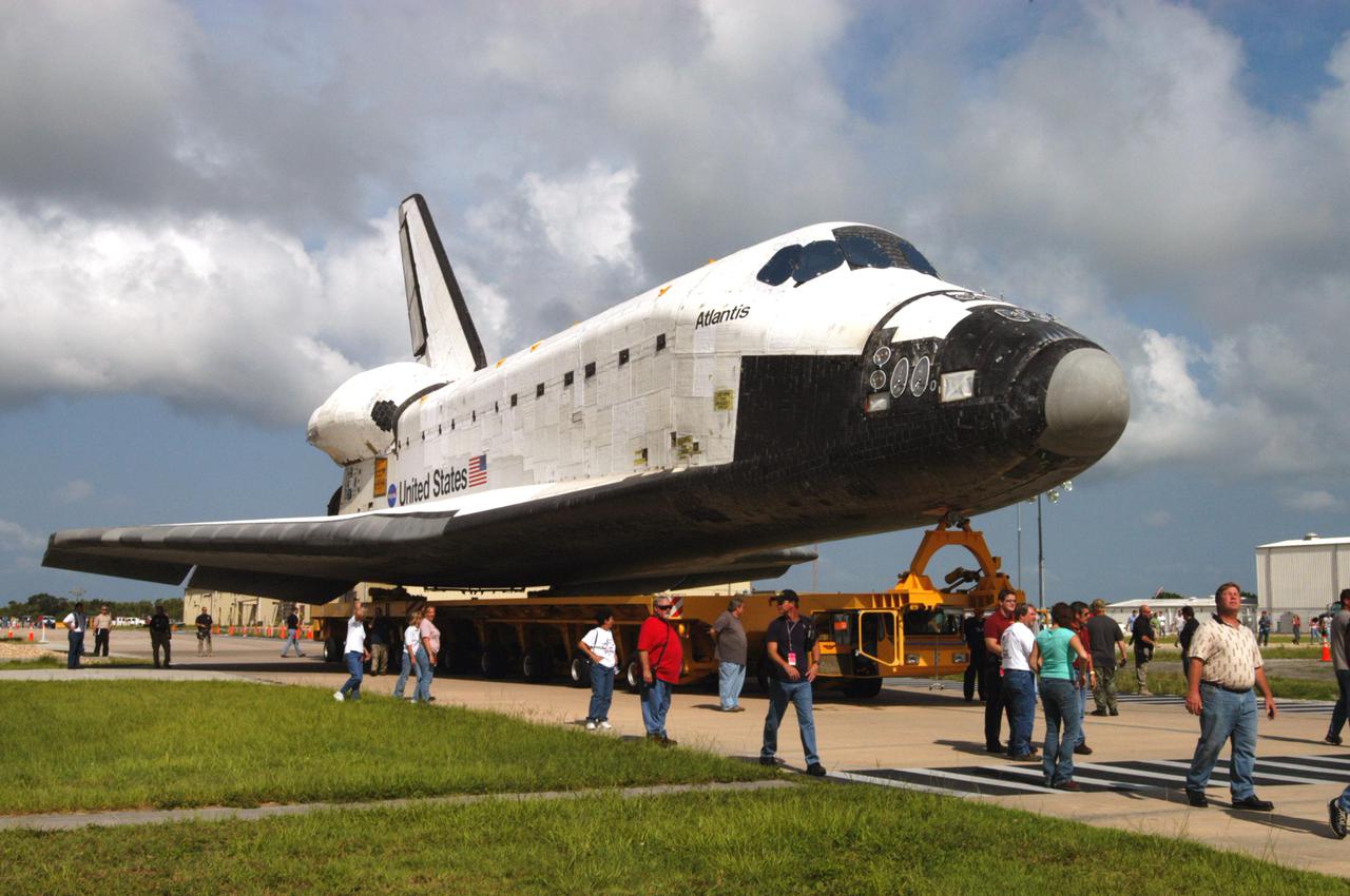 KENNEDY SPACE CENTER, FLA. -  The orbiter Atlantis, on top of the orbiter transporter, rolls toward the Vehicle Assembly Building (VAB) after exiting the Orbiter Processing Facility.   In the VAB it will be mated with the twin Solid Rocket Boosters and External Tank already stacked on the Mobile Launcher Platform.   Atlantis is being readied for mission STS-121, the second Return to Flight mission to the International Space Station.  This is Atlantis’ 27th space flight and the mission is the 18th flight to the Space Station.  It is a Utilization and Logistics Flight.  Launch is scheduled during a planning window between Sept. 9 and Sept. 24.