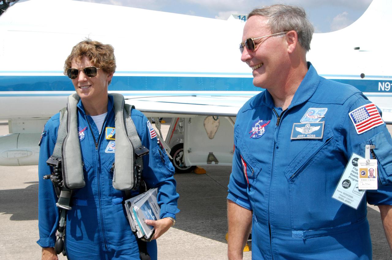 KENNEDY SPACE CENTER, FLA. -    The Return to Flight STS-114 crew arrives at NASA Kennedy Space Center in T-38 training jets to get ready for a second launch attempt aboard Space Shuttle Discovery.  Seen in the photo are Mission Commander Eileen Collins and astronaut Jerry Ross, who serves as chief of the Vehicle Integration Test Office at Johnson Space Center in Houston.  Collins later told the media who waited nearby that since the scrub on July 13, the crew has focused on the on-orbit part of the mission and training for night landings using the Shuttle Training Aircraft.  She praised the engineers and technicians who have been troubleshooting the elusive sensor problem and thanked them.  STS-114 is scheduled to launch July 26 at 10:39 a.m. EDT from Launch Pad 39B.
