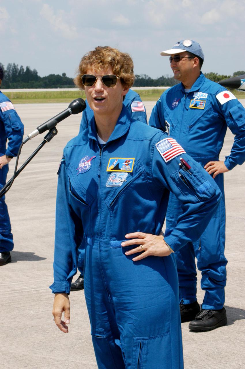 KENNEDY SPACE CENTER, FLA. - The Return to Flight STS-114 crew has returned to KSC to get ready for a second launch attempt aboard Space Shuttle Discovery. Mission Commander Eileen Collins is talking to the media who wait nearby. She states that since the scrub on July 13, the crew has focused on the on-orbit part of the mission and training for night landings using the Shuttle Training Aircraft. She praised the engineers and technicians who have been troubleshooting the elusive sensor problem and thanked them. STS-114 is scheduled to launch July 26 at 10:39 a.m. EDT from Launch Pad 39B.