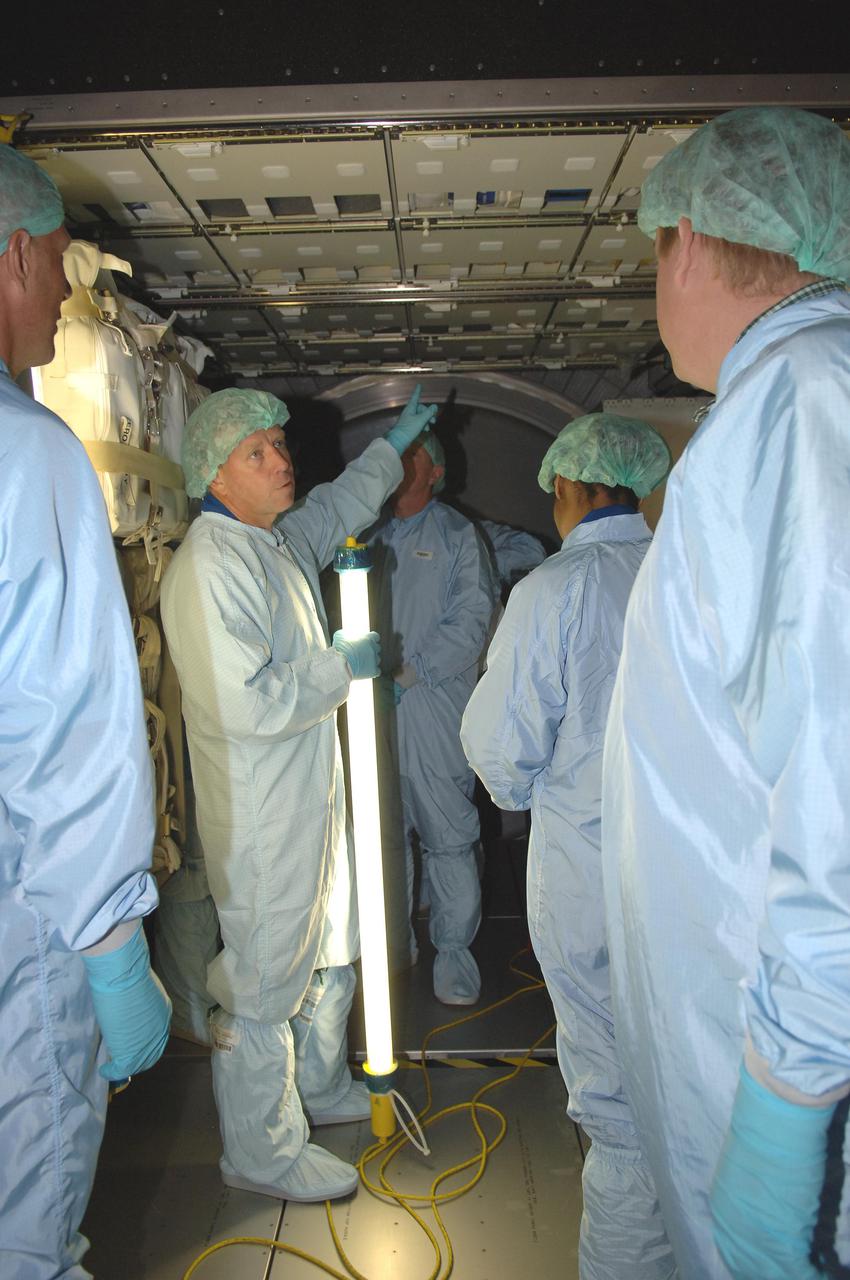 KENNEDY SPACE CENTER, FLA. - In the Space Station Processing Facility at NASA Kennedy Space Center, members of the STS-121 crew look at elements inside the Multi-Purpose Logistics Module Leonardo, which is part of the payload on the mission. The crew is at KSC to take part in Crew Equipment Interface Test activities, which provide hands-on experience with equipment they will use on-orbit. Seen pointing is Mission Commander Steven Lindsey. STS-121, the second Return to Flight mission, is targeted for launch in a lighted planning window of Sept. 9 to Sept. 25.