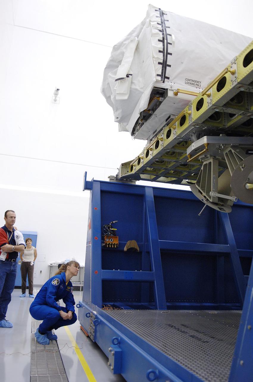 KENNEDY SPACE CENTER, FLA. -  At Astrotech Space Operations in Titusville, Fla., STS-121 Mission Specialist Lisa Nowak looks at an orbital replacement unit sitting on the Integrated Cargo Carrier.  She and other crew members are at KSC to take part in Crew Equipment Interface Test activities, which provide hands-on experience with equipment they will use on-orbit.  STS-121, the second Return to Flight mission, is targeted for launch in a lighted planning window of Sept. 9 to Sept. 25.