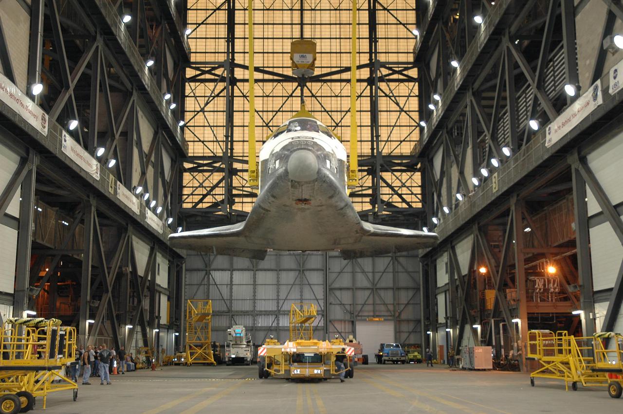 KENNEDY SPACE CENTER, FLA. -  In the transfer aisle of the Vehicle Assembly Building at NASA Kennedy Space Center, the orbiter Atlantis is lifted off the transporter.  The orbiter will be raised to a vertical position and lifted up and over the cross-beam into high bay 1 and mated with the Solid Rocket Boosters and External Tank already stacked there on the Mobile Launcher Platform.   Atlantis is the designated orbiter for Return to Flight mission STS-121.  The lighted planning window for launch extends from Sept. 9 to Sept. 25.