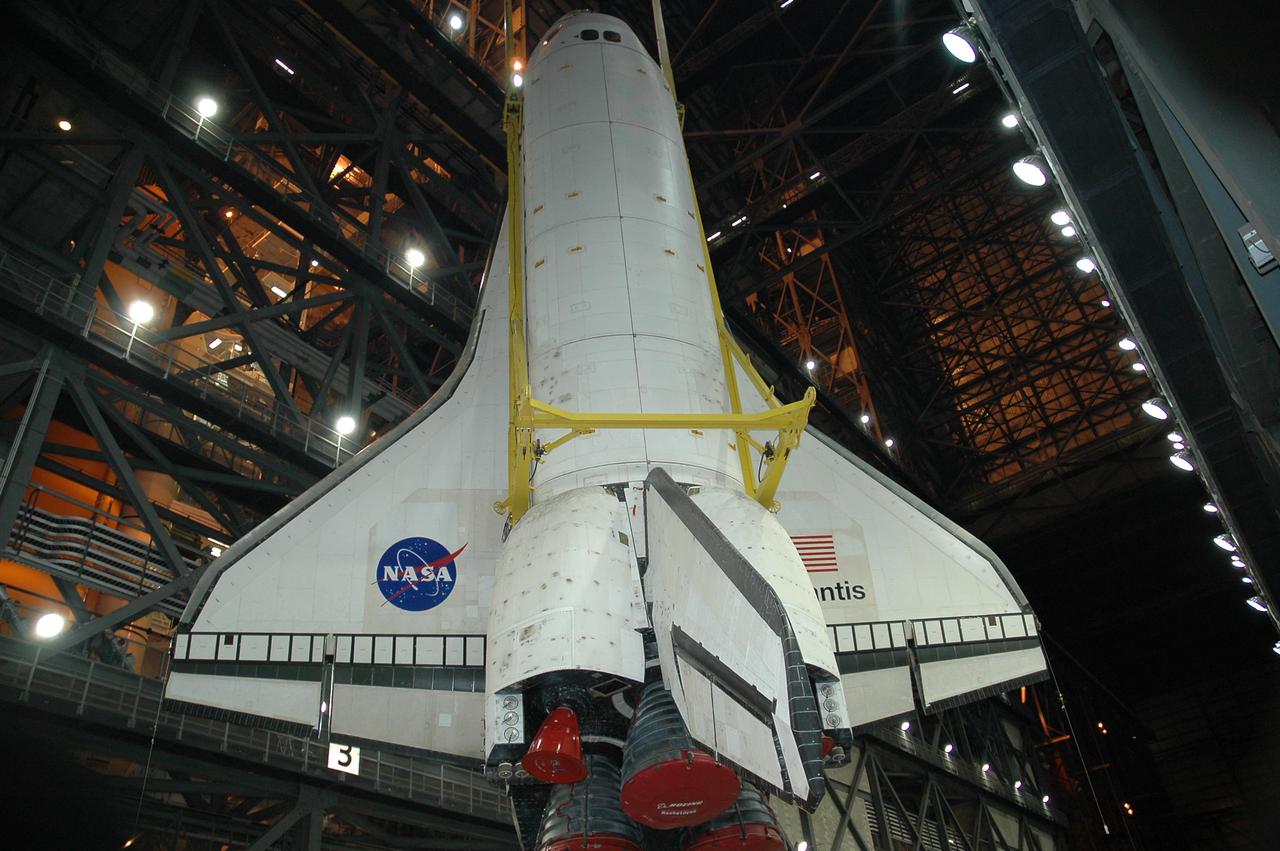 KENNEDY SPACE CENTER, FLA. - Atlantis is slowly lifted into the upper expanse of the Vehicle Assembly Building at NASA Kennedy Space Center.  The orbiter will be lifted over the cross-beam into high bay 1 and mated with the Solid Rocket Boosters and External Tank already stacked there on the Mobile Launcher Platform.  Atlantis is the designated orbiter for Return to Flight mission STS-121.  The lighted planning window for launch extends from Sept. 9 to Sept. 25.