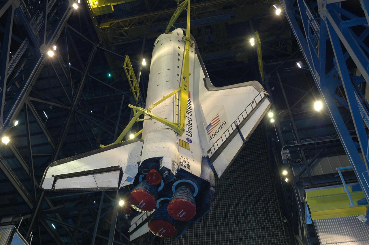 KENNEDY SPACE CENTER, FLA. - Atlantis is slowly lifted into the upper expanse of the Vehicle Assembly Building at NASA Kennedy Space Center.  The orbiter will be lifted over the cross-beam into high bay 1 and mated with the Solid Rocket Boosters and External Tank already stacked there on the Mobile Launcher Platform.  Atlantis is the designated orbiter for Return to Flight mission STS-121.  The lighted planning window for launch extends from Sept. 9 to Sept. 25.